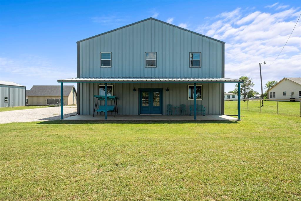 Rare opportunity to own a unique barndominium style property on 2 acres in Gunter ISD, offering full living quarters plus oversized garage and shop space. Built in 2021, this versatile property features 2 bedrooms, 1 full bath, and 3 half baths, an open living and kitchen area, laundry, and quality finishes including shaker cabinets and wood laminate flooring.

The design provides flexible use for both living and work. Downstairs includes a finished 2 car garage, mechanical room, and a break room with wet bar and half bath, along with a large workshop and storage area with an additional half bath. Upstairs offers the main living quarters with 2 bedrooms and 1.5 baths, plus an expansive open storage space of more than 3,000 sq ft, all fully climate controlled. In total, the property offers over 6,800 sq ft under roof, a rare find among barndominium style builds.

Comfort and efficiency were prioritized, with spray foam exterior insulation and fiberglass interior insulation ensuring energy savings and sound reduction. The entire building is conditioned, setting it apart from most shop and house combinations in the area.

Beyond the main building, the property offers a 24 × 50 RV garage with 50 amp breaker, floor drain tied to septic, and future sewer stub for conversion potential, plus a portable storage building. Outdoor features include a covered patio and fenced yard.

This one of a kind property is ideal for live work use, hobbies, or distinctive residential living with no city taxes, no HOA, and placement in highly regarded Gunter ISD.