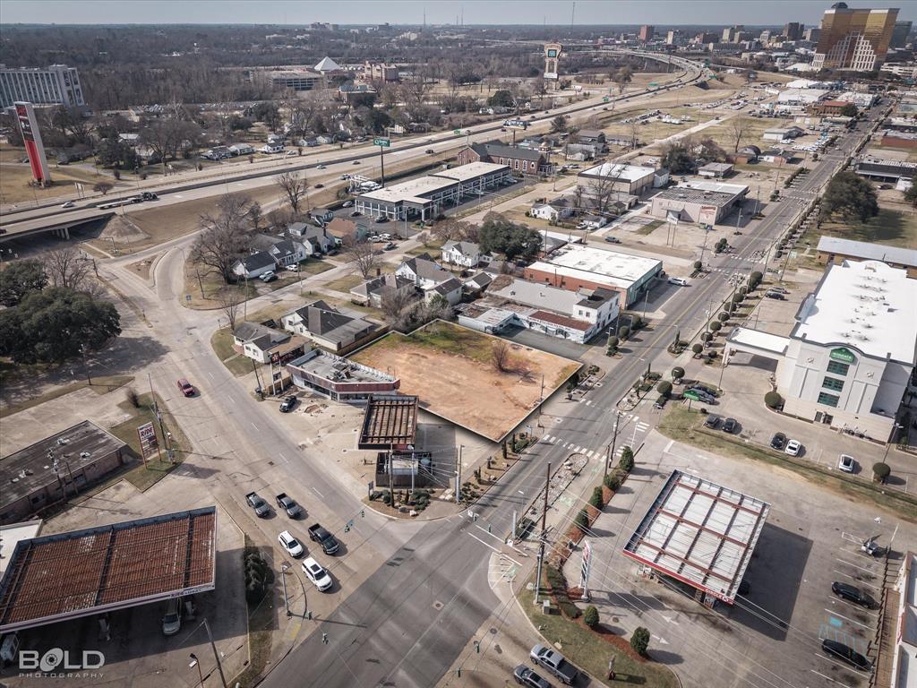 This prime parcel offers approximately 0.4 acres or 17,241 square feet with an estimated 123 feet of frontage providing excellent visibility and development potential. Located within the desirable Eastbank District this property is surrounded by thoughtful infrastructure and community focused design. The area features LED street lights a dedicated bike path sidewalks park benches and a festival plaza creating an inviting and modern environment ideal for future growth. The setting supports both walkability and connectivity while maintaining a polished urban feel. Conveniently located just one block from I 20 this property offers quick access for commuters travelers and visitors. Major entertainment destinations including Horseshoe Casino and Live Casino are located within approximately one mile adding to the appeal and potential exposure of the site. With its strategic location strong frontage and proximity to major amenities this property presents an excellent opportunity for development investment or future use in a rapidly evolving district. This is a rare chance to secure land in a high profile area that combines accessibility visibility and long term potential.