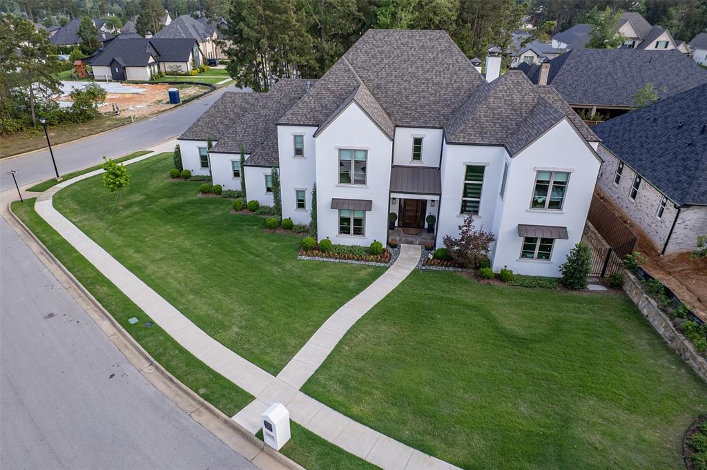 Modern meets luxury and comfort in this stunning 4-bedroom, 4.5 bathroom home conveniently located in one of Tyler, Texas’ most sought after neighborhoods. This refined property offers 4514 square feet of thoughtfully designed living space.   A cohesive interior unfolds through custom built-ins, layered lighting, and warm neutral colors. The kitchen showcases beautiful quartzite counters with a huge island for gathering around. The Butler’s pantry features custom built-ins and shelving for ample storage. A built-in microwave drawer,  added insta-hot and cold filtered water faucet, and built-in ice maker makes the space’s ease of use a chef’s delight style kitchen. Each bedroom is a serene retreat, with the sumptuous primary bedroom suite featuring an adjoining spa-like bathroom complete with large built-ins, gorgeous tile running up the wall, and a luxurious soaking tub. The spacious primary closet features additional built-ins with hidden drawer storage and room for a settee.This full-two-story home offers an upstairs bonus room as an additional living area with a kitchenette providing a beverage fridge and sink with lighting enhanced built-ins, its own sitting area, and abundant space for games or exercise equipment. Additional features such as upgraded epoxy finished floors in the expansive 3-car garage fitted with an EV outlet, retractable central vacuum, recirculating hot water, two-zoned HVAC system, spray foam insulation, and walk-in climate controlled attic storage space, reflect a level of construction designed to meet today’s modern convenience living standards. On a premier corner lot with a fully fenced backyard, the covered patio features large electric shades (creating year-round living space), outdoor kitchen that is equipped with a 32’ Blaze gas grill, sink, and 2nd fireplace all overlooking a sparkling gunite pool and spa. This home Unites style and functionality and is conveniently located near schools, medical, trails, shopping and more.