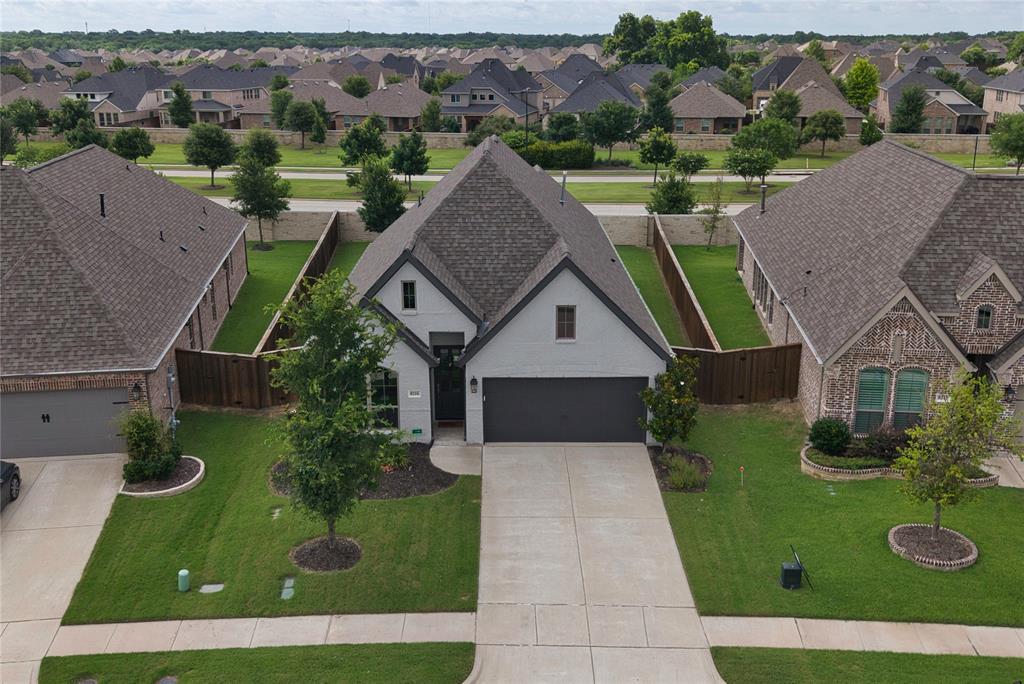 Welcome home to this beautifully maintained 4-bedroom, 2-bath home with a dedicated office and nearly 2,000 square feet of thoughtfully designed living space in the highly desirable Trinity Falls master-planned community. From the moment you step inside, you'll appreciate the light-filled, open-concept design and gorgeous upgraded hardwood flooring that flows throughout the main living areas.

The spacious kitchen is the heart of the home, featuring abundant cabinetry, ample counter space, and a bright, inviting atmosphere. The private primary suite offers a relaxing retreat with a beautifully appointed bath designed for comfort and relaxation, while three additional bedrooms provide flexibility for family, guests, or hobbies.

Step outside to enjoy the covered patio and backyard space, ideal for morning coffee, weekend barbecues, or simply unwinding after a long day.
Residents of Trinity Falls master-planned community enjoy an exceptional lifestyle surrounded by nature and resort-style amenities. This 2,000-acre community features miles of hike and bike trails, parks, playgrounds, pools, splash pads, fitness facilities, a dog park, community events, and over 450 acres of open green space. Residents also enjoy access to the 350-acre B.B. Owen Park, scenic lakes, and highly regarded McKinney ISD schools, including an on-site elementary school. Conveniently located near shopping, dining, and historic Downtown McKinney, Trinity Falls offers the perfect blend of outdoor living and everyday convenience. 

Experience the perfect blend of modern comfort, privacy, and community living in one of McKinney's most sought-after neighborhoods.