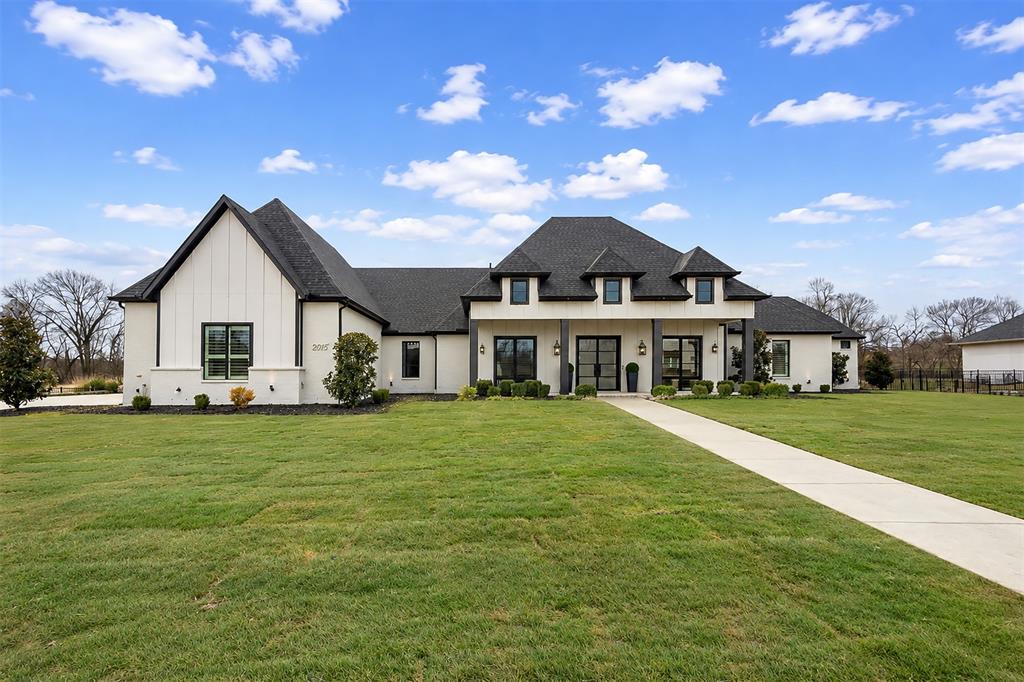 Built in 2022 by award-winning, family-owned Dave R. Williams Homes, this exceptional 4,687 square foot, north facing single story estate sits on a premium 1.5 acre lot in gated Hidden Creeks Pointe and backs to a tranquil greenbelt and creek setting. Grand double iron doors open to a light filled, open concept design with wood beamed ceilings, nailed down hardwoods, plantation shutters, designer lighting, and custom built ins. The chef’s kitchen is equipped with Sub Zero and Wolf appliances, double ovens, Bosch dishwasher, pot filler, an oversized island with built in Scotsman ice maker, and a spacious butler’s pantry. A thoughtfully split plan offers 4 bedrooms, 4 full baths and a half bath off the game room with direct access to the pool deck. Additional highlights include a home office with closet, ethernet, TV outlet and floor plug, game room, fully-loaded media room with wet bar, private gym with direct pool access, and a Texas basement for storage and HVAC access. The primary retreat features an electric fireplace, coffee bar, spa bath with separate vanities, dual walk-in closets, and additional laundry hookups in main closet. Smart-home and peace-of-mind upgrades include whole home ethernet plus multiple wireless access points, 6 to 8 exterior cameras, motorized shades, Orkin pest and mosquito proofing, and a reinforced storm shelter. A whole-home Generac generator, water treatment and softener system, and under sink reverse osmosis filtration ALL convey. Outdoor living shines with a covered patio, heated pool and spa, kitchen with grill, griddle, refrigerator, and sink, fireplace with TV outlet and speakers, turf play areas, fenced dog run, and an oversized 4 car garage with epoxy floors and built in storage. Located in Celina’s ETJ, which is outside Celina's city limits, the estimated 2025 effective tax rate is roughly 1.44% per public records, meaning materially lower annual carrying costs, and with no MUD or PID for additional long-term savings!