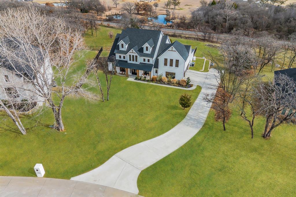 A late HOMESTEAD has been filed for this home. Taxes will be improved significantly ,,Welcome to this extraordinary custom built masterpiece in the HIGHLY sought out Prairie Timber Estates. Situated on over an acre of beautifully landscaped grounds, this one of a kind homes offers refined living with exceptional upgrades and finishes throughout. Grand double iron doors and expansive porches create a stunning first impression. Entering the grand entrance you welcomed to 5 oversized bedrooms,4 full baths, multiple living and dining areas plus spacious bonus rooms designed for comfort and entertaining. The Chef's kitchen is the heart of the home featuring custom cabinetry, designer backsplash, quartz counters, and oversized island, farmhouse sink, upgraded gas cooktop, all white appliance package, pot filler, custom wood accented vent a hood and large walk in pantry. The kitchen opens to the breakfast nook and great room. The great room boasts 10 ft ceilings, custom beams, built in cabinetry and striking stone fireplace and overlooks the resort style setting. Step outside to your private retreat with a saltwater oasis and spa. Enjoy 2 covered patio enclosures for extended outdoor living, a full size pool bath that connects to a spacious bonus room. Your primary suite Ofers a spa inspired bath with oversized tub, double vanities, custom tile and built ins. Secondary bedrooms are generously sized, some with window seating and custom padding.The additional upstairs bonus room adds space and flexibility. A few highlights include upgraded flooring,powershades,a large laundry room with built ins,3 car garage with extended driveway, permanent jellyfish lighting , and so much more! Luxury at this level in Prairie Timber Estates is SELDOM available. Claim your private showing before its spoken for!