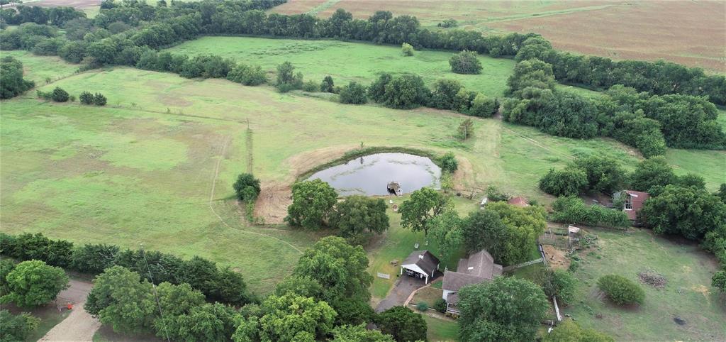 ***Charming country property situated on approximately 17.7 acres in Farmersville, TX in COLLIN COUNTY. This 3-bedroom, 2-bath home offers 1,720 sq ft of living space and is ideal for those seeking peaceful rural living. The property features open land, a tree-lined creek, and a stock pond, perfect for agriculture, recreation, or building your dream home. Enjoy extensive road frontage and convenient access to nearby growth areas, including the future Collin County Outer Loop. Home to be sold as-is.***
