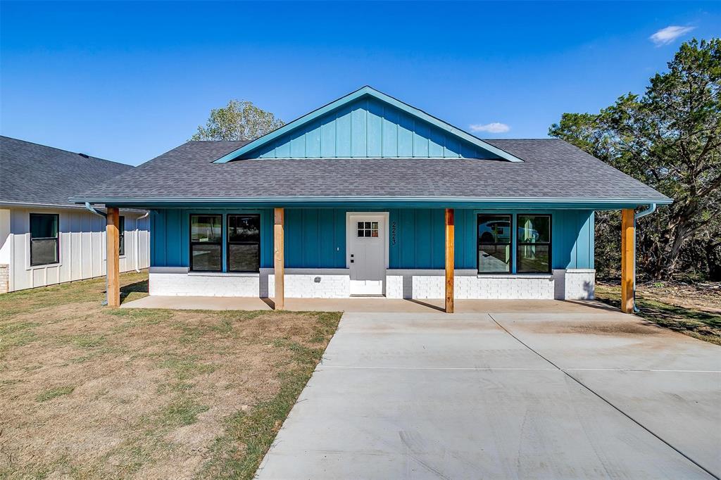 Price Improvement! New construction craftsman home, located just minutes from the Granbury Square. The exterior of this 3 bedroom 2 bath home features a combination of board and batten siding and brick with an oversized front porch. As you enter, you are greeted by an open concept living and kitchen area. Large windows allow ample natural light to fill the space, creating a bright and airy atmosphere. Concrete floors and upgraded fixtures add an extra level of elegance. The primary bedroom includes an ensuite bathroom with walk-in shower as well as a large closet with a variety of storage. The separate laundry room provides additional storage space and helps keep the living areas clutter-free. Stainless steel appliances, including a range, microwave, and dishwasher are included with the home. Enjoy private lake access and a community boat ramp with easy access to the lake. Rate buy down available thru preferred lender.  Contact listing agent for more details!!