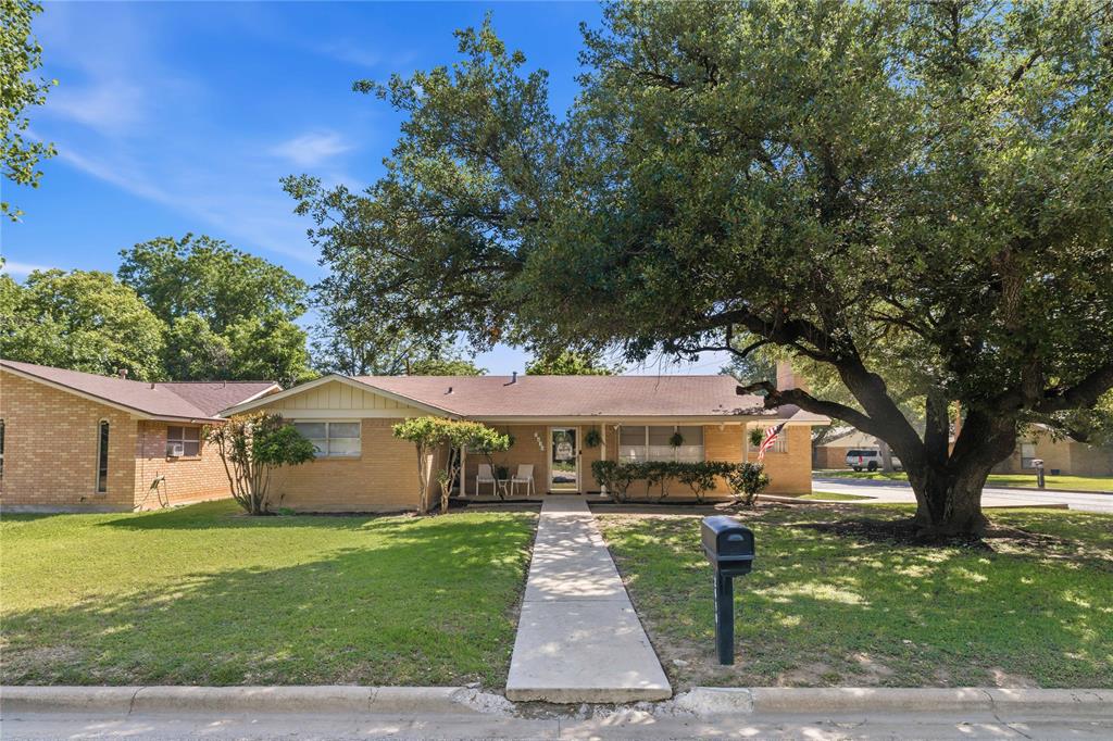 Attention to every single detail! Set on a beautiful corner lot, 2410 14th Street is a outstandingly maintained 3-bedroom, 2-bath home with wonderful curb appeal and thoughtful updates throughout. From the inviting front porch to the private backyard, every detail has been carefully considered to create a home that feels fresh, functional, and move-in ready. Inside, you’ll find porcelain tile floors, a comfortable layout, modern bathroom finishes, and a welcoming living room centered around a wood-burning fireplace. The kitchen features stainless steel appliances, ample counter space, an island, and seamlessly flows into the living room for everyday living, while the front and back porches offer great spots to relax and enjoy the outdoors. The backyard is private and includes additional storage, plus a unique bonus feature—access to an additional third garage space currently used as a guest room, complete with a window unit, backyard access, and thoughtful updates, this flexible space could also serve as a hobby room, office, workout room, or guest retreat. Located close to Brownwood High School, in the Woodland Heights school district, and convenient to Brownwood’s medical and industrial districts, this home offers comfort, style, and a great location. With meticulous maintenance (including central air conditioning unit replacement in 2023), fresh updates, and attention to every detail, this one is truly a must-see!