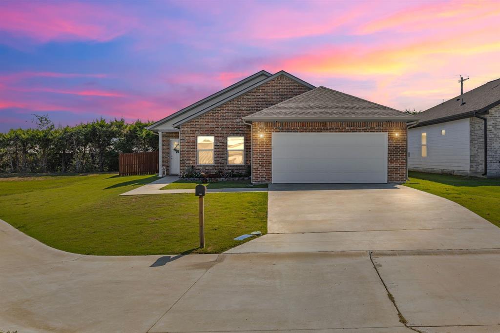 At the end of a cul-de-sac, sits this 4 bedroom, 2 bath brick home in Woodcreek Addition--just off College Street! A bonus feature of solar panels and battery backups, already installed, allows you to save money on bills. Once you step inside, the luxury vinyl plank flooring creates a seamless elegance in the open floor plan from the living area, to the dining, kitchen, and bathrooms. The family chef will appreciate the granite countertops, island with breakfast bar, stainless steel appliances, custom white shaker cabinets, and pantry. The dining room includes access to the covered back patio and privacy-fenced backyard. Recessed lights and a raised ceiling in the living and kitchen elevates the space with an extra touch of detail. At the back of the house, the primary ensuite includes a trey ceiling and enjoys views of the spacious backyard. The primary bathroom comes with granite countertops, double sink, walk-in shower, and walk-in closet. Three guest bedrooms, at the front of the house, share a hall bathroom with granite countertops. Ceiling fans are found in each bedroom and the living area. A dedicated laundry room leads to the attached 2-car garage. Wood-fencing on this large lot also provides an excellent place for entertaining. On a quiet street, make this 2023-built home your very own!