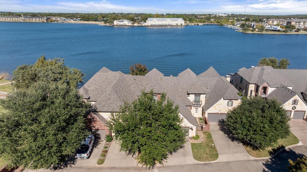 Waterfront Luxury Living at its best!!!
Welcome to this stunning 2-bedroom, 2.5-bath waterfront home perfectly situated on the highly sought-after Lake Granbury. From the moment you arrive, the elegant brick and stone exterior, manicured landscaping, and private drive set the tone for the timeless beauty that awaits inside.
Step through the entryway into a bright, open-concept living space featuring large windows that frame breathtaking panoramic lake views. The living room flows seamlessly into a spacious dining area and gourmet kitchen — perfect for entertaining or quiet evenings by the water.
The primary suite offers a serene retreat with tranquil lake views, a spa-inspired bathroom, and generous closet space.  Additional bedroom, family room, bonus room and a second full bath, on the second floor, provide comfort and flexibility for guests or family.
Outdoors, you’ll love the expansive stone patio overlooking the water, ideal for morning coffee, sunset gatherings, or hosting lakeside dinners under the trees. The property’s iron fencing and natural landscape create both beauty and privacy and incredible waterfront views.
Located just minutes from shopping, Downtown Granbury, and local dining, this home combines luxury, convenience, and unmatched views — a rare opportunity on Lake Granbury’s mainbody shoreline.