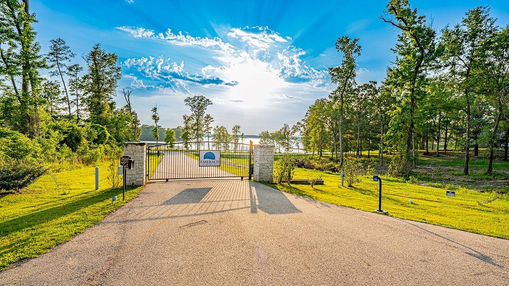 Gorgeous 1+ acre waterfront lot on Lake Bob Sandlin. Bring your own builder! Plans have been completed by an architect and owner will sell if interested. At the bottom of the newly installed steel lake wall you will find a sandy bottom for wading and playing in the water.  This amazing lot offers 275 feet of shoreline and the views of sunsets are amazing! Septic system is required when building.