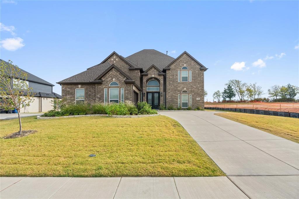 Discover the epitome of luxury living in this exceptional 2023 First Texas Home, offering 4,734 sq ft of thoughtfully designed space and a grand double staircase that creates an unforgettable first impression. Designed for both elegance and functionality, this 5-bedroom, 3.5-bath home showcases a seamless open-concept layout filled with natural light and refined finishes throughout.

The expansive living area is anchored by a striking stone fireplace, creating a warm yet sophisticated gathering space. At the heart of the home, the chef’s kitchen impresses with sleek marble countertops, abundant cabinetry, and a generous island—perfect for everyday living and elevated entertaining.

Designed with lifestyle in mind, the media room features a built-in bar, ideal for hosting movie nights or entertaining guests in style. The primary suite offers a private retreat, complete with a spa-inspired bath featuring an oversized freestanding soaking tub, a custom walk-in shower, and a spacious layout that exudes comfort and luxury.

Step outside to a large, covered patio overlooking a generously sized backyard, providing the perfect setting for outdoor dining, relaxation, or future customization. Additional highlights include well-appointed secondary bedrooms, flexible living spaces, and modern design elements that enhance both form and function.

Situated in a peaceful, established community with convenient access to major highways, shopping, and dining, this home offers the perfect balance of tranquility and accessibility.