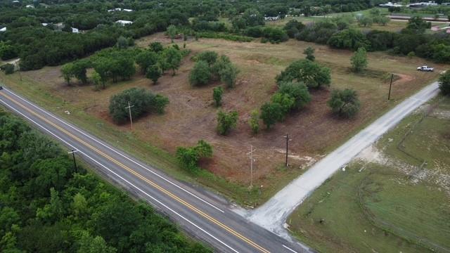 Rare opportunity to own 3.215 acres in one of the most strategically located areas between Granbury and Glen Rose. This versatile property features two access points from County Road 324, offering the unique flexibility to build a private residence toward the rear of the property while operating a business with excellent visibility along State Highway 144. The property is also available with the adjoining tract, creating a combined 6.79-acre package with substantial highway frontage and even greater development potential.

Located outside city limits with no known zoning restrictions, the property offers a wide range of possibilities including residential, investment, recreational, agricultural, or potential commercial uses. With utilities available and exceptional visibility from a major traffic corridor, this property is positioned in the path of continued growth as both Granbury and Glen Rose continue to expand.

Whether you're looking to build, invest, establish a business location, or secure land for future development, opportunities with this level of highway exposure and location are becoming increasingly difficult to find. The option to acquire both adjoining tracts creates an even more valuable investment opportunity with significant Highway 144 frontage and long-term upside potential.

Conveniently located just minutes from historic downtown Glen Rose, Lake Granbury, shopping, dining, schools, and recreational attractions while maintaining the privacy and flexibility of rural acreage.
