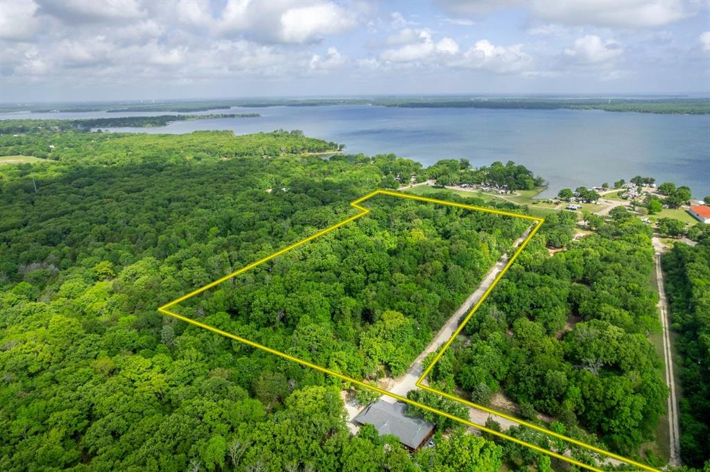 This 10-acre Hunt County lot offers lake views and convenient access to Lake Tawakoni, a 37,879-acre reservoir in Northeast Texas known regionally for catfish, bass, and crappie fishing. Located just south of Greenville and a short drive from Wills Point, the property provides a rural setting with utilities already in place to support a range of uses, from a primary residence to a weekend retreat.
The lot features 440 feet of road frontage and private road access, providing seclusion without sacrificing connectivity. Electricity and water are available at the site, reducing the typical groundwork associated with raw land development. Lake views add a notable visual asset without the cost or maintenance of direct waterfront ownership.
A public boat ramp is located approximately two miles from the property. Lake Tawakoni State Park, a short drive away, offers a four-lane boat ramp, hiking and biking trails, a kid-friendly fishing area, campsites, and cabin rentals available throughout the year.
Regional access is strong. Greenville is approximately 12 miles north, Rockwall approximately 29 miles west, and Dallas approximately 49 miles away, placing the property within roughly one hour of the Dallas suburbs. This combination of rural land, available utilities, lake views, and metropolitan proximity makes this Hunt County acreage a practical option for buyers seeking recreational or residential land in Northeast Texas.