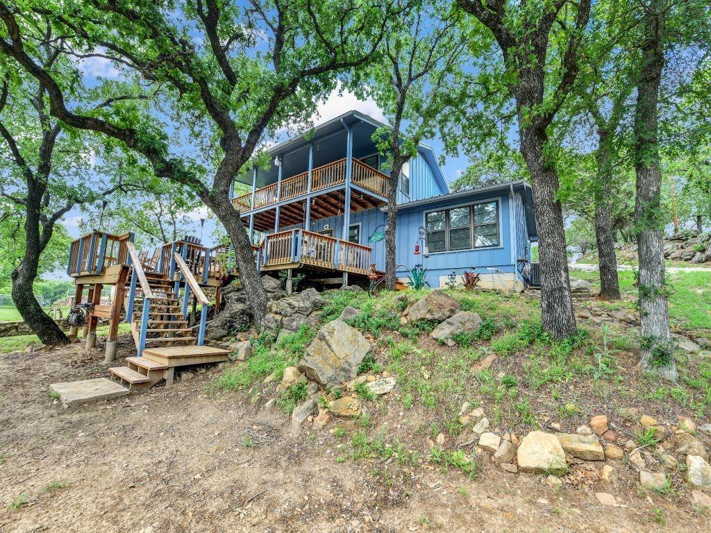 Here is your dream waterfront home all with a cozy quiet country atmosphere on the beautiful and desirable Lake Palo Pinto.
This exceptional home sits back in the large oak trees on the quiet Deer Trl. cove just steps from the lake for you to enjoy your very own private boat dock and everything else this lake has to offer.
Your private dock has a large boat slip with an electric boat lift and 2 Perma port jet ski docks for those to remain safe while you are not on them. The dock has automatic lighting that can be adjusted to any one of 12 colors at the push of a button or select a color palette for each holiday along with several power outlets. Relax and get some sun on the docks 240sf. of open deck area. This dock is where the average lake water depth is 10 to 12 feet deep. The dock is equipped with 2 large stand-up sheds and several deck boxes, along with under seating storage to store all your life jackets, fishing poles and other lake fun supplies. It also has a fish cleaning table with sink and running water mounted on the dock for your easy fish cleaning catches. Or just hosing down anything you want.
Sit on your 600 sf. tree covered back deck that is short steps to the water. And enjoy the peaceful sounds of nature or use this large space for entertainment or family fun gatherings.
This home is equipped with separate climate-controlled AC Heat units for the lower level and the upper level for all occupants to remain as comfortable as they choose.
This home’s water supply is furnished by LPP Water District but also has its own independent water well to aid in watering of the lawns or other tasks at no charge.
This home is equipped with a top-of-the-line Harmon Accentra 52i TC Pellet Burning Fireplace Insert. This insert is completely automatic and will light and adjust the temperature by using its separate thermostat. While this fireplace is burning and heating the home the furnace doesn't kick on saving you hundreds of dollars through the winter months.