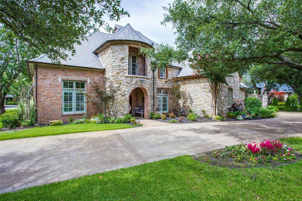 Enjoy serene living in the heart of Preston Hollow in this updated home.  Situated on a corner lot near a private lake and trail, this home in the Lakes of Preston Hollow has a grand two story entry opening to formal dining and living.  The living room and library share a double-sided fireplace.  Light and bright kitchen with island and breakfast area is open to a stunning two story great room with beamed ceiling  and stone fireplace.  Primary suite and guest bedroom are located on the first floor.  Upstairs features three additional bedrooms and a media room with wet bar and a game room with a balcony.  Not to be missed is the resort style backyard with pool and spa with plenty of space for entertaining.
