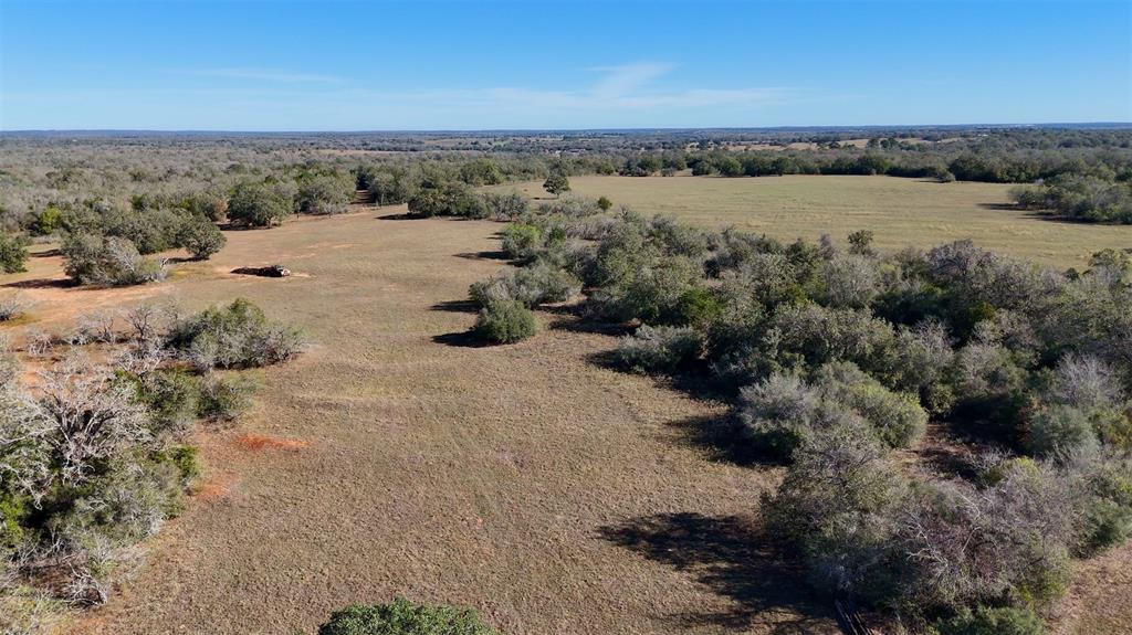 Staples Sothebys International Realty is honored to present this expansive land offering on behalf of the Aurelia Mitchell Estate.Positioned near Austin, San Antonio, and Houston, this 668 acre tract delivers the scale, access, and opportunity you're looking for.With direct access along IH10, State Highway 90, and County Road 283 in Harwood, this property offers rare connectivity for large-format development, agricultural expansion, or recreational uses. This land features a classic southern post oak savannah feel—broad,open grassy areas mixed with mottes of post oak, live oak, and blackjack with yaupon holly and cedar understory. Improvements includefencing and cross fencing, several seasonal tanks as well as a portion of the property being improved pasture. Ranchers, hunters, anddevelopers alike will appreciate the lands utility with its sandy loam soil, gently rolling topography, and multiple points of access.Bordered by IH10 to the south and State Highway 90 and the railroad to the north, this property offers a strategic position for investmentor future development. If a smaller tract better aligns with your needs and goals, the seller is open to dividing the 668 acres into twosmaller tracts. Tract 1 being 284 acres and Tract 2 being 384 acres. Large acreage of this quality and accessibility rarely hits themarket. Call today to schedule a private tour.