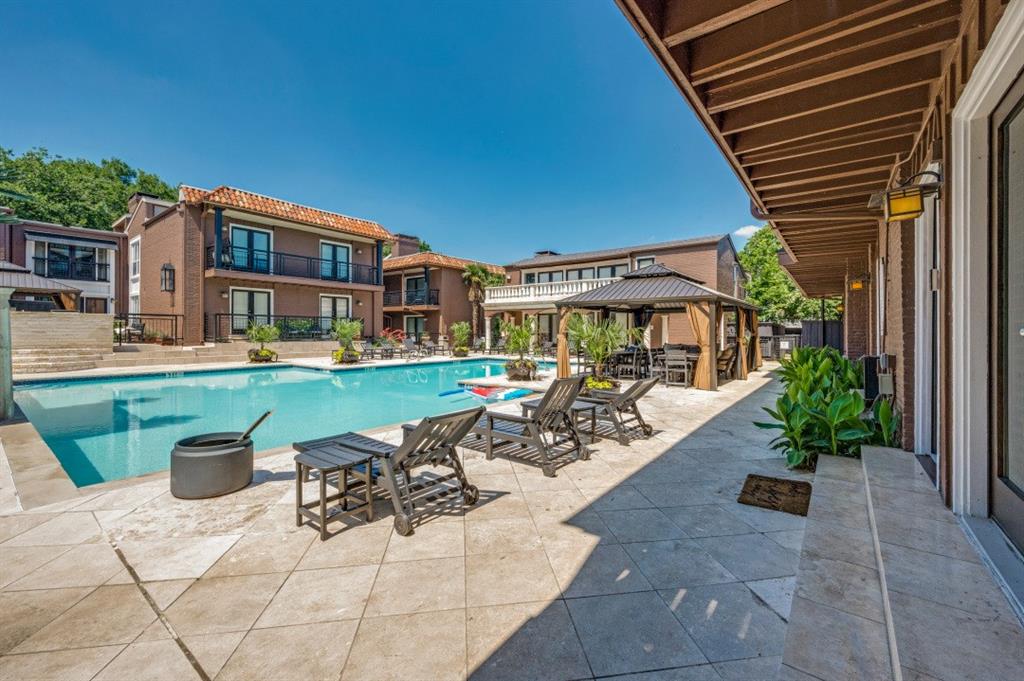 Rarely available first-floor corner residence in the highly sought-after Tuscany Condominiums, offering an exceptional blend of comfort, style, and convenience in one of Dallas’ most desirable locations. This beautifully updated 2-bedroom, 2-bath condo features engineered wood flooring throughout, fresh interior paint, abundant natural light, and a thoughtfully designed open-concept layout ideal for everyday living and entertaining.

The inviting living area is anchored by a striking double-sided fireplace that seamlessly connects the living, dining, and kitchen spaces. The kitchen offers stainless steel appliances, granite countertops, generous prep space, and a functional layout designed for easy living. Newly replaced French doors enhance both the aesthetic appeal and energy efficiency of the home while providing access to the spacious private patio—perfect for entertaining, relaxing, or pets.

The spacious primary suite features a large walk-in closet and ensuite bath, while the secondary bedroom offers flexibility for guests, a home office, or additional living space. Refrigerator, full-size washer, and dryer are included. Two assigned covered parking spaces are conveniently located just steps from the rear entry.

Tuscany Condominiums recently completed an impressive $900K community-wide renovation and offers resort-style amenities including a sparkling pool with separate hot tub, fitness center, grilling stations, fountains, beautifully landscaped courtyards, and secure gated access.

Ideally located near SMU, Central Market, Lower Greenville, Mockingbird Station, White Rock Lake, Katy Trail access via Ridgewood Trail, and major commuter routes, this home offers exceptional access to Dallas’ premier dining, shopping, entertainment, and outdoor recreation. A rare opportunity to enjoy low-maintenance living in one of Dallas’ most desirable gated communities.