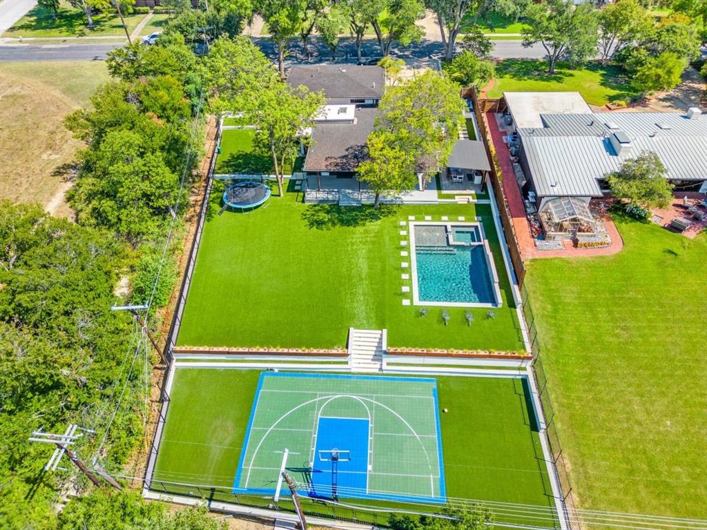 A rare Mid-Century Modern estate where history, privacy, and nature converge in one of Dallas' most extraordinary settings. Originally commissioned in 1955 by Trammell Crow for his mother and thoughtfully restored and expanded from 2022–2024, this architectural masterpiece blends timeless design with modern luxury.
Privately positioned on more than half an acre at one of the highest elevations in Dallas and backing directly to Norbuck Park, this home offers an experience almost impossible to replicate within city limits. Surrounded by mature trees, sweeping views, and remarkable privacy, it feels less like a Dallas residence and more like a private resort retreat hidden within the city.
The outdoor living is truly unforgettable and serves as the heart of the home. Designed for entertaining and everyday escape, the grounds feature a sparkling pool and spa, full-size sport court, expansive covered deck, and exceptional outdoor kitchen with dual refrigerators, grill, cooktop, beverage fridge, and granite bar overlooking the park and surrounding landscape. Private access to Norbuck Park hiking trails creates a seamless connection to nature just beyond your backyard.
For dog lovers, this property is a dream, complete with its own private enclosed dog park and pet-friendly design where four-legged family members can safely run and play.
Inside, walls of glass and expansive sliding doors bring the outdoors in, filling the home with natural light and creating effortless indoor-outdoor living. The thoughtfully designed floorplan features 4 bedrooms, 3 baths, multiple living areas, chef's kitchen, private guest suite, and spa-inspired primary retreat while preserving the home's iconic Mid-Century character.
Homes offering this level of history, privacy, and resort-style living rarely become available. More than a home, this is a private sanctuary and a true Dallas legacy property unlike anything else on the market.