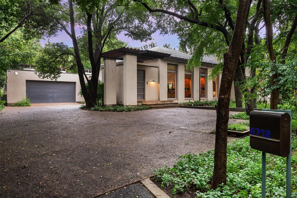Stunning Max Levy designed home hidden on .6+ acre heavily treed lot on Wildwood Rd.Warm modern aesthetic captures the light,air, privacy of the setting.Lush exterior envelops the house.Natural material inside &out Arizona sandstone Texas limestone,shellstone & pink granite mahogany paneling white oak flooring.Almost hidden driveway leads to wood battened metal front door. Spacious foyer.Great Room w frplc adjoined by dng area & rich mahogany paneled kitchen.Expansive windows doors throughout. Fabulous art walls.1st floor includes 2 bdrms w Jack & Jill bath, screened porch,serene study.Primary suite w frplc occupies entire 2nd floor.Opens to tranquil porch overlooking front grounds.Retreat-like primary bth.Light permeates through numerous windows. Beautiful cabinetry built ins. Large glass doors open to a rear patio grassy yard, guest house-studio with wine storage. Attached 2 car garage off mudrm & kitchen office. Towering magnolias & native trees create walls of privacy.
