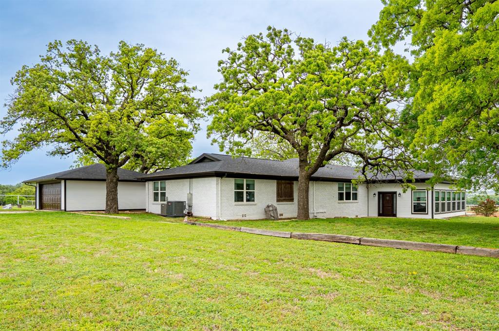 Roping, Racing & Riding - Stunning 10-acre Horse property features are extensive with tons of space on a quiet paved road – NO restrictions just outside of Stephenville! This spacious 3500+ sqft Smart-home has tons of room with 4 bed, 3 full baths, as been fully updated Top to Bottom – New Roof, Flooring, Kitchen, Fixtures, Appliances, Bathrooms, HVAC, Well, Septic and more! Featuring an open inviting floorplan, Kitchen with Double ovens perfect for all your baking desires. Breakfast Bar & Dining area overlooking the spacious Family and Game rooms with Rock Fireplace-Wood burning stove and the perfect views of the arena. The peaceful Master Bedroom retreat features an ensuite bath, extra deep Soaking tub, with Rock Shower & Dual Shower heads. 3rd bed-bath could be used as second primary or MIL suite. Large Office that comes with additional entry could be used as a 5th bedroom, Laundry & separate Mud room. Sit on the back porch overlooking the large backyard and Lake in the distance with a cup of coffee where you watch breathtaking sunrises and sunsets. Patio with separate deck gives you views of the Arena for miles to go, offering a built in Fire pit perfect for grilling under the stars. 2500gal Water Storage tank. Large 8 stall Horse barn has all the features - 2 large Tack-Feed rooms with Saddle Tree-Racks, Tie rack, Horse Walker, Turnout pen & Round pen. 100x200 Lighted Arena with spring loaded Calf Chute, Stripping Chutes, Catch pens, Return alley, Holding-Sorting pens, Roping boxes & Judges box, makes it perfect for hosting Play days or just good practice! Dairy barn used as Gym & separate Shop office with attached catch-sorting pens, larger holding pens & loafing sheds. Enclosed 40x40 shop with 2 rollup doors & 3 additional open bays perfect for storing your RV, trailers, & any other toys.
