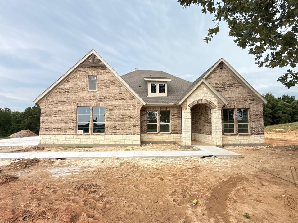 Estimated July 2026 completion! Ask us about our Trade In Trade Up program, we can buy your home! The Verbena floor plan features a modern, open-concept layout and the sought-after features today’s homeowners are searching for. With four bedrooms, three bathrooms, and a flex room, this plan boasts just over 2,400 square feet of functional living space. Upon entering the home off the front porch, you’re welcomed by an inviting foyer. Immediately to the left is a hallway with a bedroom, walk-in closet and full bathroom, as well as a linen closet. Across the foyer is a flex room, perfect for a home office, formal dining room or whatever need your family has for the space. Past the foyer is the family entry, with storage space and mud bench, which leads to the laundry room and two or three car attached garage. Through the entrance, the home opens up to a large family room with a stately fireplace. Adjacent to the family room is a gourmet kitchen, equipped with a walk-in pantry, ample counter space and an oversized island. Finishing off this open-concept living area is a dining space which overlooks the covered back patio. The remainder of this one-story floor plan is just off the living space. A hall leads to two bedrooms with walk-in closets, another linen closet and a shared full bathroom. The back corner of the home offers privacy for the owner’s suite, featuring a massive walk-in closet and bathroom with a dual-sink vanity, standalone soaking tub and glass-enclosed shower.