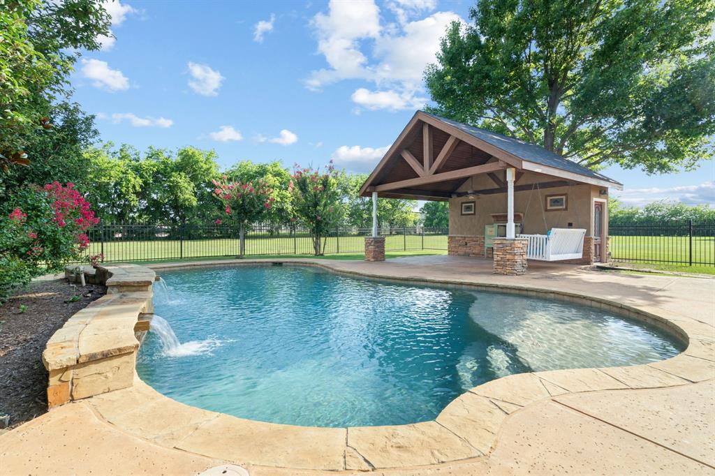 Located on just over an acre in the highly desirable Hills of Argyle, this beautifully maintained one-owner home offers the perfect combination of space, comfort, and privacy. With approximately 3,700 square feet, this single-story floor plan features 4 bedrooms, 4.5 bathrooms, a dedicated office, game room, and split-bedroom layout designed for everyday living.
Built using the innovative KORE Insulation System, this home was designed with energy efficiency, comfort, and durability in mind. Insulation at both the walls and roofline creates a conditioned attic space that remains remarkably comfortable year-round, providing abundant storage without the extreme temperatures typically found in Texas attics. The result is exceptional energy performance, lower utility costs, and a home that is solidly constructed and comfortable in every season.
Natural light pours through the home, creating a bright and welcoming atmosphere. Thoughtful details throughout, including charming plantation shutters in the family room and breakfast nook, add character and timeless style. Recent updates include fresh paint, updated lighting, ceiling fans, plumbing fixtures, and a new roof, making this home truly move-in ready.
The spacious backyard is designed for enjoying Texas summers with a sparkling pool, cabana, mature trees, and beautiful landscaping, all set on a peaceful one-acre lot. A 3-car garage provides ample space for vehicles, storage, and hobbies.
Residents of The Hills of Argyle enjoy a friendly neighborhood atmosphere with walking trails, mature trees, and a community pond for catch-and-release fishing. Located in acclaimed Argyle ISD and zoned for Hilltop Elementary, this exceptional property offers the peaceful feel of country living with convenient access to shopping, dining, and major commuter routes. It's a must see!