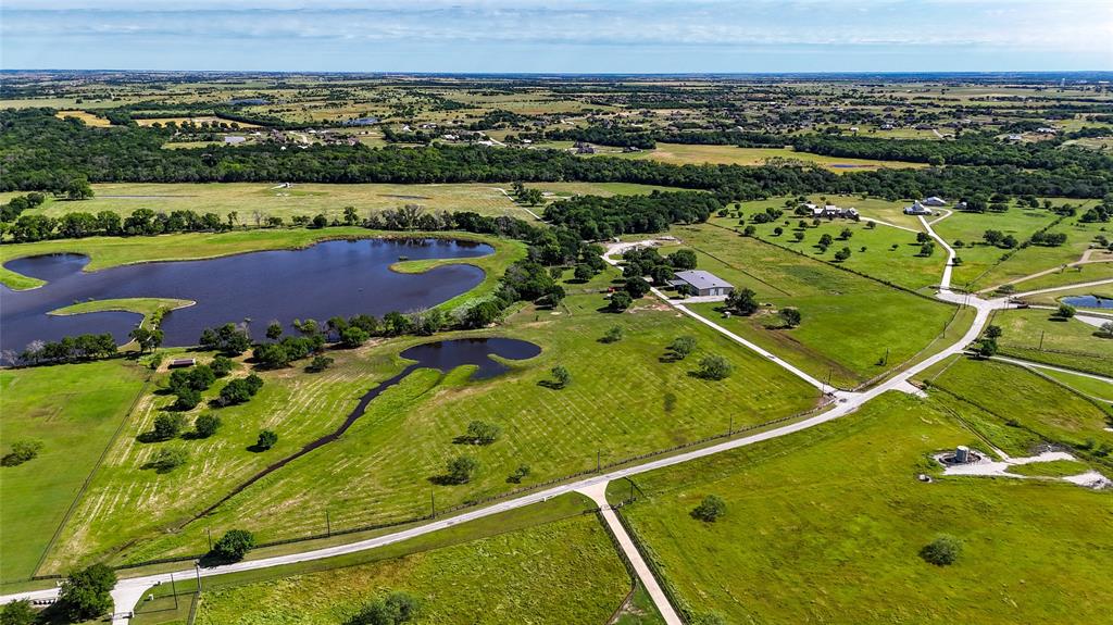Located on the border of Justin and Ponder, Texas, discover a ranch estate with lush woods and sprawling pastures perfect for cattle, horses, or hunting. The property features a 12,000 square foot barndominium with 3,738 sqft of living quarters including 3 br's and 3 ba's with a steam shower. If you love entertaining, you won't find a better area than the media room with a full bar that opens up to the shop. Great for hosting parties! Blending rustic charm with modern comfort this barndo is set up perfectly. Situated along Denton Creek, the ranch offers access to a private lake, ideal for relaxation and recreation. For outdoor enthusiasts, the ranch provides prime hunting grounds with deer, turkey, and hogs. Property also features a high low skeet range. Ranch is cross fenced with working pens for cattle. 25x50 lean to with attached chicken coop. Less than 45 minutes to DFW Airport and downtown Fort Worth. Come enjoy country living at it's finest!