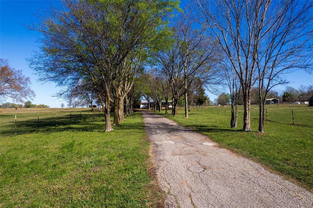 Mt. Vernon, Texas country living that proves you don’t have to rough it to enjoy the quiet life. This 3 bedroom, 2 bath home with nearly 1,500 square feet blends modern finishes with classic East Texas charm. Before you ever step through the front door, the wide front deck may win you over. Spend one evening sitting out there under the Franklin County stars and you’ll understand why folks dream about country living in Northeast Texas. Inside, you’ll find a thoughtfully designed home featuring quartz countertops in both the kitchen and primary bath, shiplap walls that bring warmth and character, and a farmhouse sink that anchors the kitchen perfectly. This isn’t your grandma’s old country farmhouse—but it still carries that comfortable, welcoming feel everyone loves. The primary suite sits just off that incredible front deck and features a beautiful ensuite bath, creating a private retreat for the homeowner. The two additional bedrooms offer real space—not the tiny afterthought rooms you sometimes see—making them ideal for family, guests, or even a home office. Just off the kitchen is a dedicated laundry room that keeps everything convenient for the homeowner who wants to cook supper, toss in a load of laundry, and still catch the game. Outside, the property continues to deliver practical country features including a screened-in porch, large carport, and a workshop space long enough to build a goal post—perfect for projects, hobbies, or extra storage. There’s also a storm cellar, an East Texas feature that brings both character and peace of mind. Located in the Mt. Vernon area of Franklin County, this property offers the space, comfort, and quiet country lifestyle buyers are searching for today. Coach Solly says if you’re looking for a country place where modern comfort meets East Texas stars, you might want to take a look at this one before someone else beats you to it.