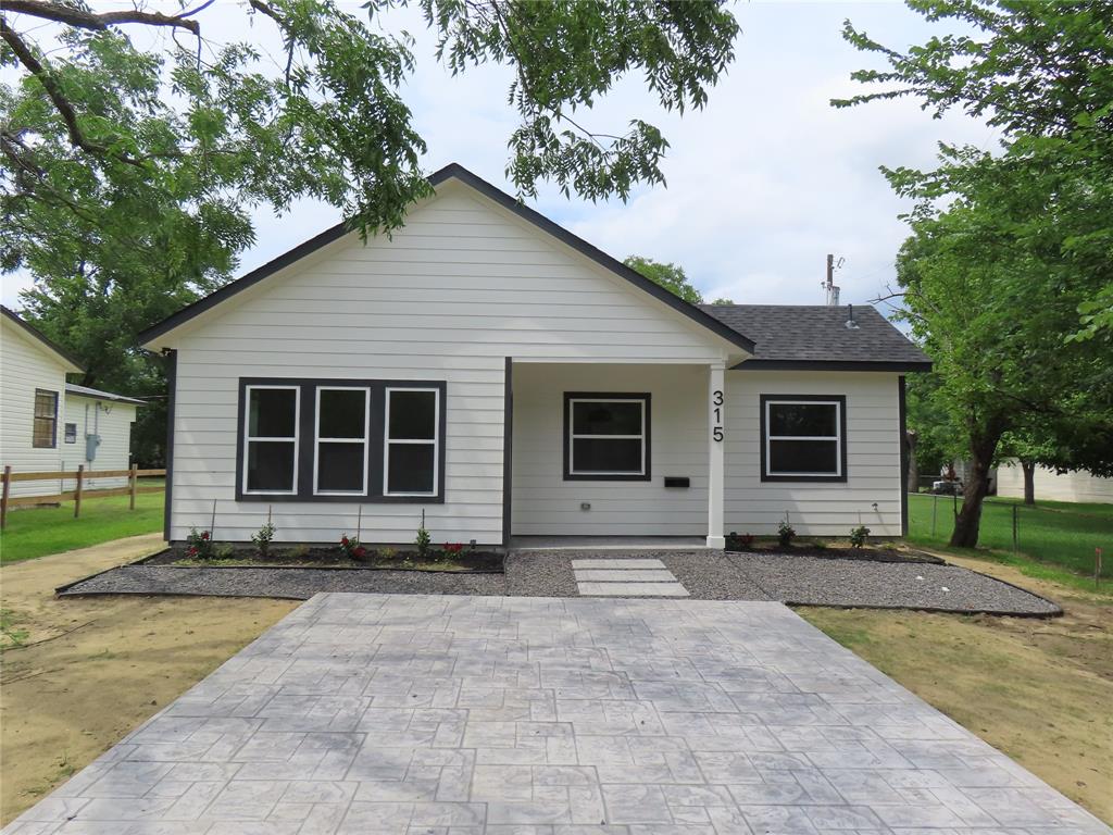 Beautiful new construction in the heart of Wills Point offering 1,225 square feet of thoughtfully designed living space, complemented by a versatile 750-square-foot insulated metal shop with remote bay door opener. The open-concept floor plan features quartz countertops, custom cabinetry, and quality finishes throughout, creating a modern and inviting atmosphere.

Outside, you'll find a stamped concrete driveway and patio that enhance both functionality and curb appeal. Built with durability and longevity in mind, the home incorporates premium materials, including a 30-year architectural shingle roof designed for lasting performance.

The insulated metal shop provides exceptional flexibility and is ideal for a workshop, storage, home-based business, or hobby space. This rare property combines the benefits of brand-new construction with a highly functional outbuilding—all conveniently located within city limits.