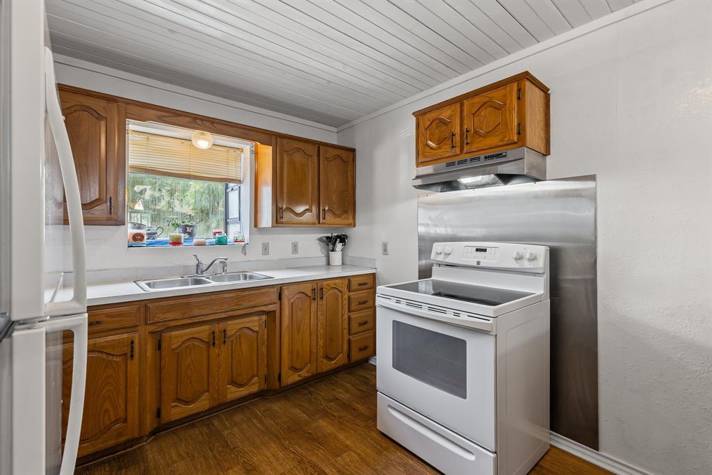 We need your offer. PRICE HAS BEEN DROPPED. This is a very nice Country Style brick home with a spacious living room and dining room in a small town community. 3 BR, 2 BA w ceiling fans & nice light fixtures throughout. The Kitchen has plenty of counter and cabinet space plus a bar for those quick meals. The bedrooms have ceiling fans, large closets w shelving space. The front door is a storm door and the windows are double pane for efficiency. The garage is over sized & has a large Double door with an electric door opener plus an extra 5' x 7' room for a shop or special storage.  The property has nearly a half of an acre and a 2 car carport that is detached. Grocery Stores, restaurants & hardware stores are 10 min away. McKinney, Greenville & Sherman are 30 minutes away. The property has some nice tree's and grass. Call for your appointment to see what could be your next house. We are looking for a reasonable offer.  Have a great day:)