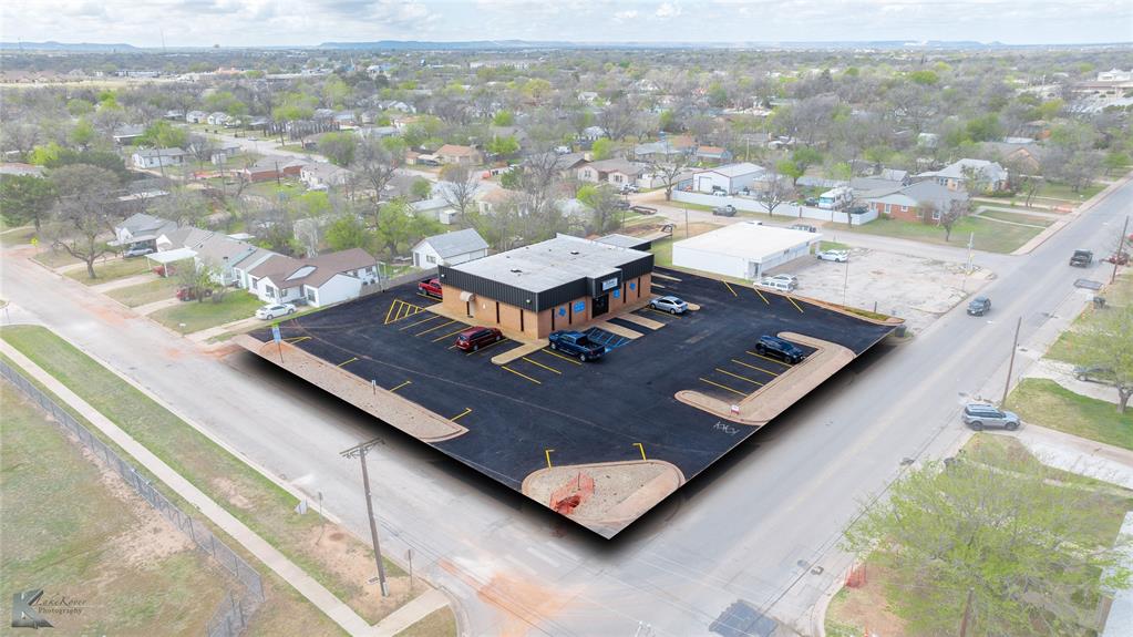 FOR SALE: Commercial Space in SOUTH Abilene, TX. Discover an exceptional opportunity to establish your business in a highly versatile commercial property. Situated on a prominent corner lot, this property blends robust infrastructure with strategic positioning, making it ideal for various business ventures. With its brick exterior and multiple ingress and egress points, this site promises seamless accessibility and visibility for clients and customers alike. Designed with functionality in mind, the interior layout boasts a spacious central hub room, ideal for collaborative workspaces or customer interactions, surrounded by 6-8 smaller rooms that can serve as offices, consultation areas, or private meeting spaces. The property includes two restrooms, ensuring convenience for staff and customers, and a breakroom for employee downtime. It offers four doors for ingress and egress, facilitating smooth and efficient movement within the premises. The property’s exterior is equally versatile, offering 2-3 lane drive-through capability, perfect for businesses requiring quick service or drop-off solutions such as QSRs, delivery, or retail establishments. Benefiting from alley access and an expansive asphalt parking lot, visitors and staff will enjoy hassle-free access. Its location directly adjacent to Bowie Elementary provides added visibility and customer traffic, while being easily accessible to the bustling south shopping district on Buffalo Gap Road enhances its appeal. This commercial property lends itself perfectly to a variety of uses, including office space, retail outlets, delivery and drop-off services, or even a restaurant or quick-service restaurant (QSR). The layout and location combine to offer a dynamic environment adaptable to your business needs, fostering growth and success. Contact CJ to arrange a private viewing or to gather more detailed information. Elevate your business presence with this outstanding commercial opportunity in the heart of Abilene.