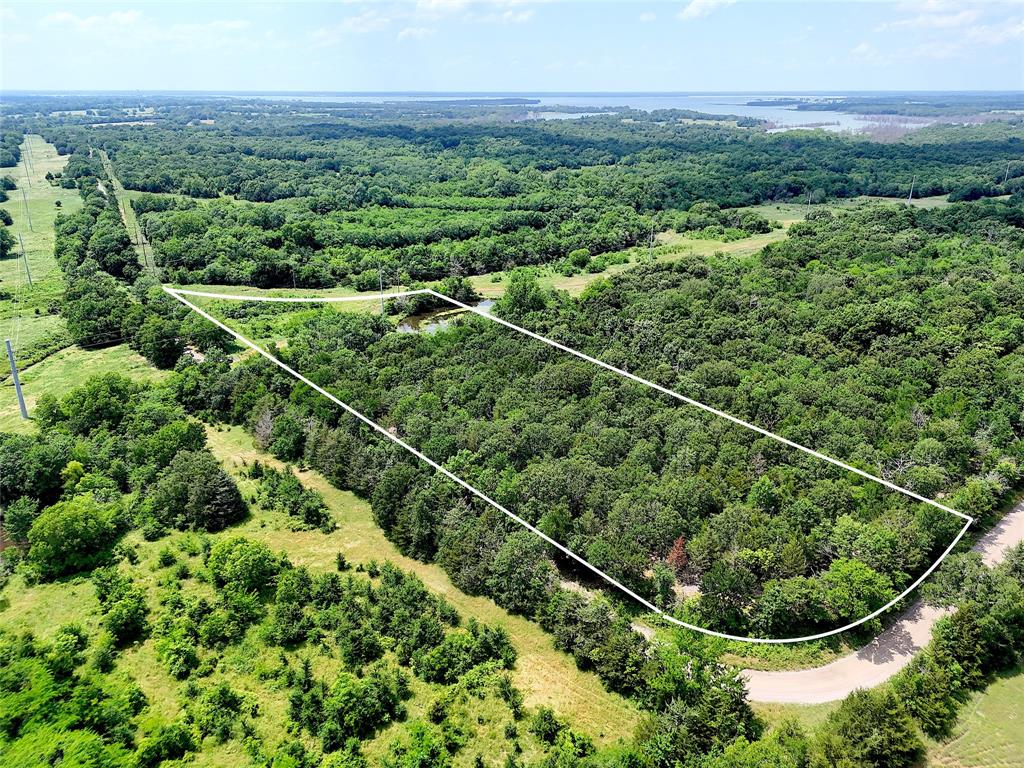 Quiet property nestled up to Honey Grove Creek. Mix of both mature hardwoods and open meadow. This tract offers a diverse landscape for your ideal home site or recreational use. This property is backed by North Texas Municipal Water District property, and serves as a haven for the local wildlife. Great gravel road frontage along the southern and eastern boundaries (1375'). Water line Located on property. Just minutes from the FM1396 Boat Ramp.