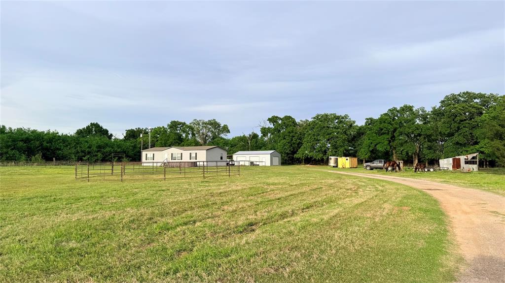 Endless possibilities and PRICE TO SALE on this this 3.43-acre property! Perfect for investors or families looking to live together with room to grow!
Spacious 3 bed, 2 bath manufactured home, Large detached garage, workshop – ideal for projects or storage
Fully fenced property – ready for livestock, plenty of room to add additional homes or structures
Whether you're looking to expand, invest, or create a multi-generational homestead, this property offers flexibility and value.
Country setting with solar powered gated entry. This home features an open living, kitchen, dining area with a large walk-in pantry. Spacious Master bedroom with huge bathroom featuring double sinks, shower and large bathtub plus walk in closet. The other 2 spacious rooms each have large walk-in closets as well. Features a 40x30 shop on concrete with 3 bay doors and 3 horse stalls built on with solar powered lighting. Above ground pool included. Large heavy metal round pen for working and training horses. Nice yard fenced off from the remaining acreage for the little pets and kids. Eustace school district, conveniently located between Mabank, Gun Barrel and Eustace with easy access to Hwy 334 and Hwy 175 for your commute to Dallas. Bring your horse and other livestock, plenty of room for family get to togethers and outdoor activities. Lots of opportunity to add more of your own personal touches. Shared property with listing 190 Railroad St.  Tractor and all attachment available on separate addendum.