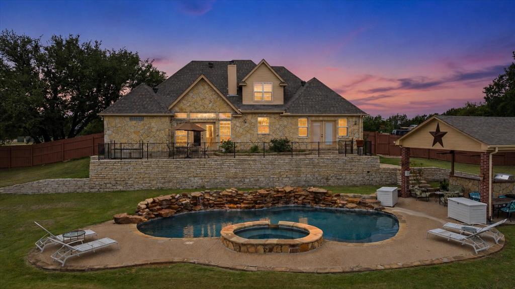 Welcome to this exceptional Glen Rose property offering space, functionality, and resort-style outdoor living! This beautiful two-story home features 3 bedrooms, 3 full bathrooms, bonus room, and a 2-car garage. The spacious floor plan provides comfortable living with room for everyone. Step outside to your private backyard oasis complete with an in-ground pool with spa and stunning waterfall feature, perfect for relaxing or entertaining. Close by in the covered cabana with built in kitchen and grill. Situated on a large corner lot, the property offers plenty of room to enjoy both indoor and outdoor living. A standout feature is the impressive shop with a second-story space ideal for a home office, man cave, craft room, game room, or additional flex space to fit your lifestyle. Whether you're looking for a place to work, create, or unwind, this property has it all. Located in the heart of Glen Rose, this unique property combines small-town charm with exceptional amenities and endless possibilities.