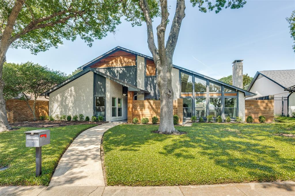 Located in the desirable Town Creek neighborhood of Lake Highlands, this charming home greets you with mid-century style, curb appeal, and a courtyard-style area just off the front entry. Inside you will find an open and spacious layout full of charm with rich wood flooring flowing throughout the entire first floor, including the primary bedroom. The family room is highlighted by vaulted ceilings, brick fireplace and a striking wall of windows that brings in tons of natural light. Prep meals in the kitchen that is complete with granite countertops, a backsplash, stainless steel appliances and an abundance of cabinetry for storage. The eat-in breakfast area and wet bar overlooks the backyard, creating the perfect spot for casual dining. Downstairs also includes a versatile den that works perfectly as a home office or additional living space, along with a convenient half bath featuring granite counters. Unwind in the primary suite with an en-suite bathroom that has granite countertops and an oversized dual-head shower for a spa-like experience. Head upstairs where you fill find two spacious secondary bedrooms, each with a walk-in closet, along with a jack and jill bathroom. Outside, a large covered patio offers shade from the sun where you can relax and watch the kids play or enjoy family BBQs on the weekends. All of this, plus walking distance to the elementary school and unbeatable location just minutes from 635 and 75 for a quick commute.