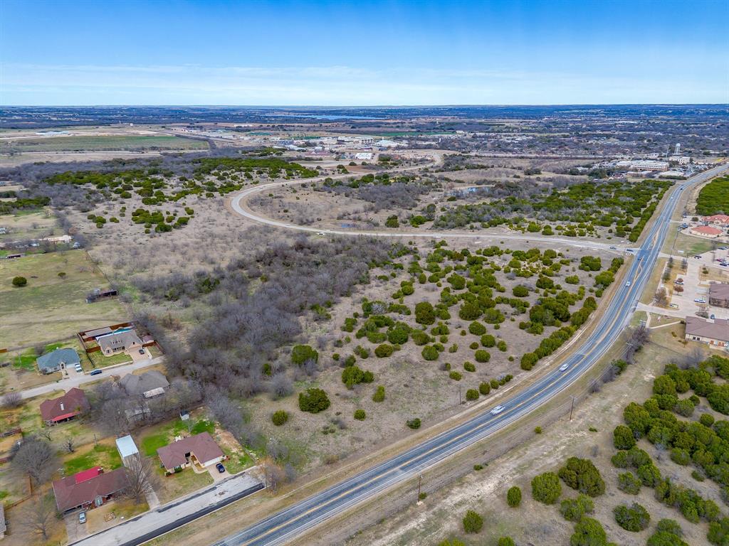 This property is ideally located in the heart of Granbury’s growing commercial corridor, near Granbury Hospital, Granbury High School, multiple medical office buildings, and Granbury Regional Airport. Situated at the highly visible intersection of S. Pirate Drive and U.S. Highway 377, the site offers excellent exposure and accessibility. Utilities include sewer available at the front of the property, with access from both S. Pirate Drive and Highway 377, adjacent to the new 7 Eleven. The location and infrastructure make this site well suited for a variety of commercial uses, including medical office, retail, or service-oriented development (buyer to verify zoning and permitted uses). This is a prime opportunity in a rapidly developing area with strong traffic counts and surrounding commercial activity.