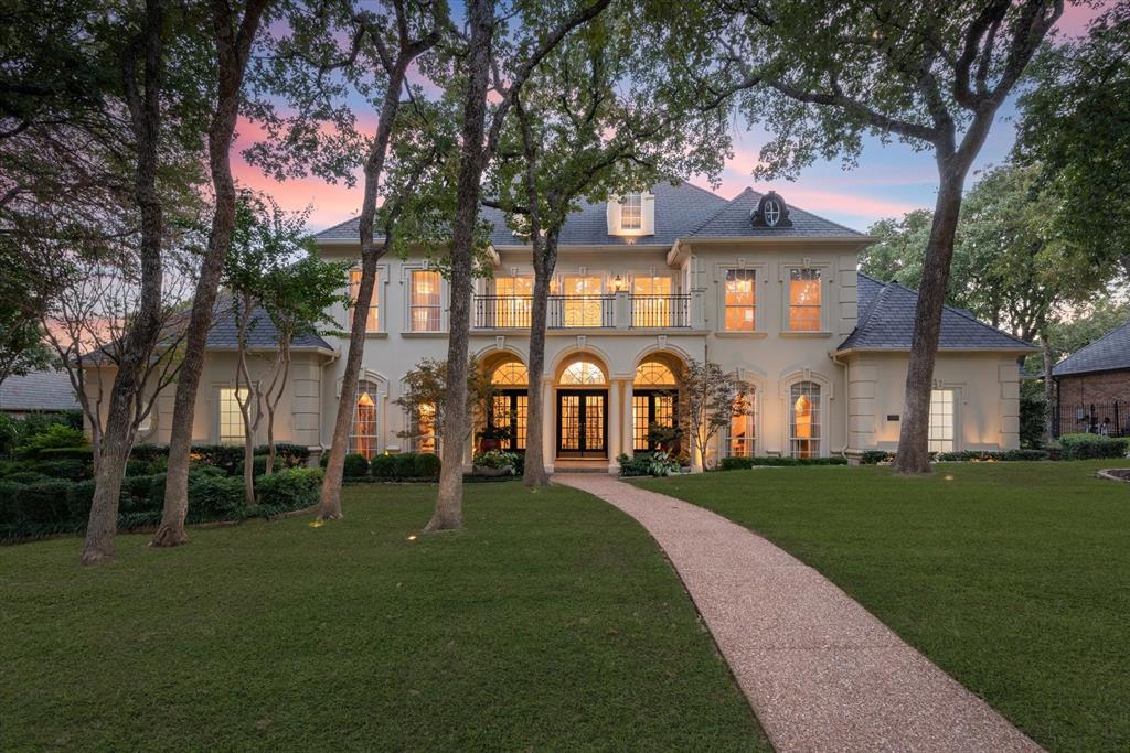 Welcome to 1218 WYNDHAM HILL LANE - a stunning transitional home in Southlake’s exclusive gated neighborhood of Wyndham Hill. This grand 5-bed, 5.5-bath home is beautiful inside & out. The property is surrounded by walking trails, lakes & parks — perfect for a morning stroll. The bright & airy great room overlooks a luscious green-belt and features floor-to-ceiling Pella energy-efficient windows. Enjoy a modern chef’s kitchen, designed for style and function. Boasting state-of-the-art Sub Zero, Wolf & Miele appliances, including a 200+ bottle wine and beverage center — ideal for the entertainer. A galley sink makes food prep & clean up a breeze. The spacious primary bedroom includes a formal seating area & motorized black-out shades. Its ensuite bathroom has in-floor heating & a hidden television. The other four spacious bedrooms and ensuite bathrooms have wood floors & marble bathroom features. Other standouts are the wood-paneled library, nature-filled backyard, and a craft room.