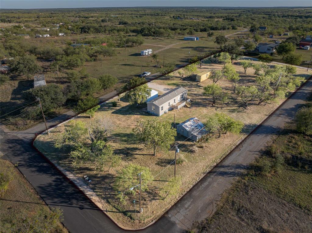 Affordable & Move-In Ready!!! Updated 2-bedroom, 2-bath 2015 manufactured home on an entire block totaling nearly an acre. Features an open floor plan, central heat & air, fresh paint, new carpet, and all-electric utilities. Kitchen includes stove, dishwasher, refrigerator, plus washer & dryer. Primary suite offers a private bath with walk-in closet. Relax on the back deck and enjoy peaceful evenings. Two storage sheds provide plenty of extra space. Owner financing available! Great value for first-time buyers, investors, or downsizers. Buyer and or buyer's agent to verify all information.