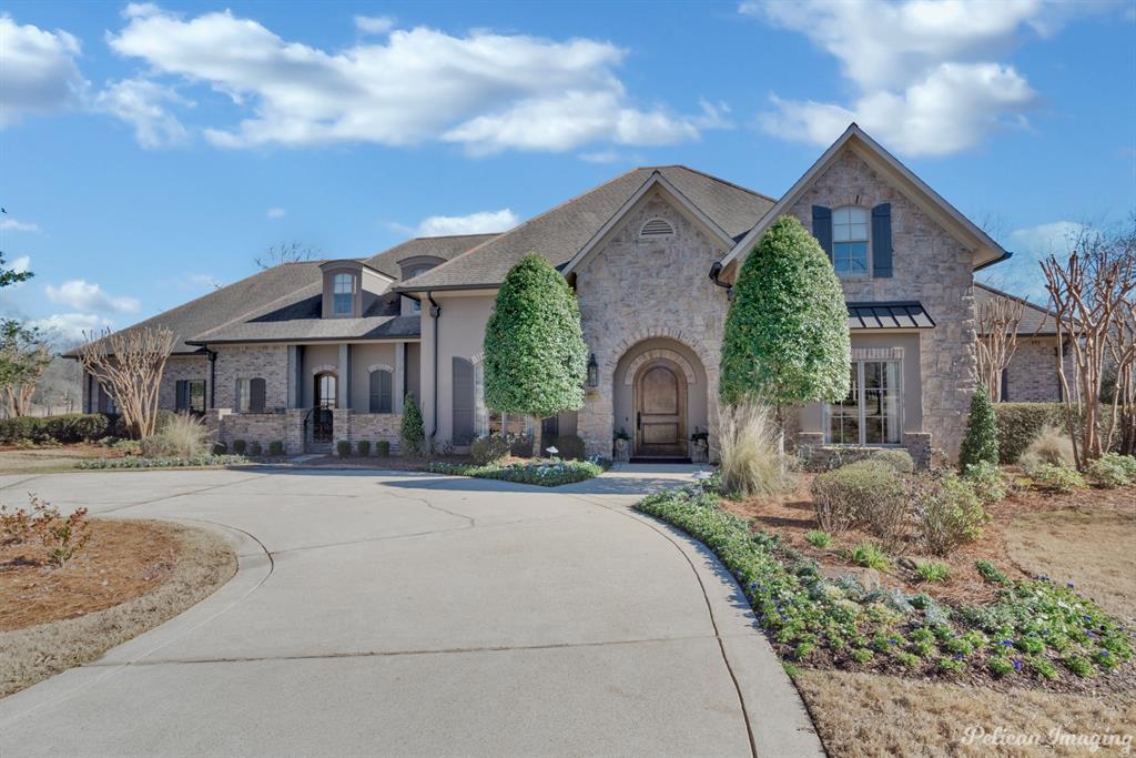 Experience unparalleled luxury in this architecturally distinctive home in Southern Trace on a serene double fairway.  Spacious formal dining room with wood floors and brick archways leading to the beautifully appointed living area with views of the golf course.  Enjoy the gourmet kitchen equipped with a Sub-Zero refrigerator and freezer, an ample island, built-in wine storage, a 6-burner gas cooktop, and a Butler’s pantry. Hearth room with built-ins, fireplace and access to the back patio. The master suite on the first floor is an oasis of tranquility offering a spa-like bath, a steam shower, and a custom walk-in closet. Private study with built-ins and access to the master suite Upstairs, find 3 more bedrooms and a comfy den. With a fully appointed outdoor kitchen, a fireplace, and an infinity pool with a hot tub, this home is certainly an entertainer's delight.