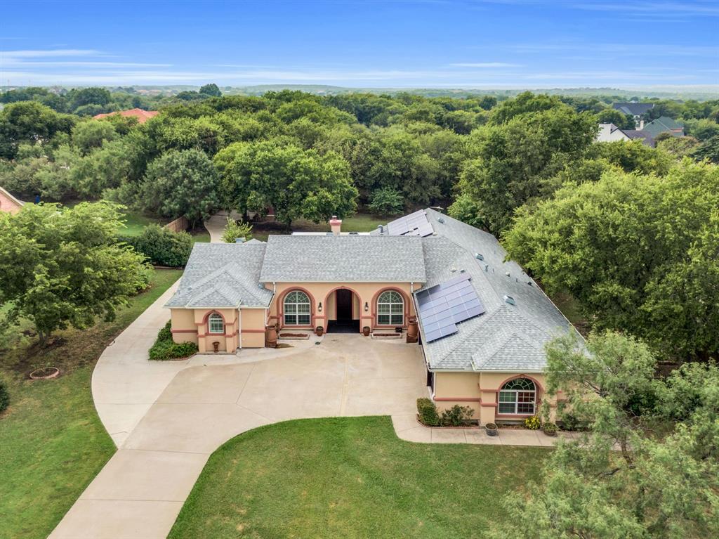 1 AC. HOMESITE - LOW HOA - VERY LOW ELECTRIC BILLS - SHORT DRIVE TO JOE POOL LAKE! Rare floor plan featuring two primary suites, each with an en-suite bathroom  .   Step into timeless elegance with this stunning Spanish-style home nestled on a sprawling 1-acre lot in the heart of Cedar Hill, TX. Boasting 4 spacious bedrooms, 3 full bathrooms,  this home perfectly blends style and functionality. The open, split-bedroom floor plan offers both privacy and flow, while two inviting living rooms and a formal dining room provide the perfect backdrop for everyday living or entertaining. The updated kitchen shines with modern touches, making it as practical as it is beautiful. Inside, you’ll find thoughtful details that set this home apart. The free standing wood burning fireplace creates a cozy focal point in the main living area, while the large utility room offers ample storage to keep your home organized. The expansive master retreat is a true sanctuary, complete with a spacious ensuite featuring a separate jetted tub and shower, double vanities, and plenty of room to unwind bonus that it has a private patio that connects with the main patio! Every corner of this home was designed with comfort and convenience in mind. Please see MLS docs for a list of upgrades! New roof in July 2024 that is a class 4 high impact shingle - will get insurance deduction on home owners insurance with this shingle. Outside, the lifestyle continues with a large gated backyard, ideal for both relaxation and play. A huge covered patio provides shade for weekend barbecues, morning coffee, or evening gatherings under the Texas sky. With low HOA fees and plenty of space both indoors and out, this property delivers the perfect mix of privacy, charm, and everyday luxury—all within easy reach of Cedar Hill’s shopping, dining, and recreation.