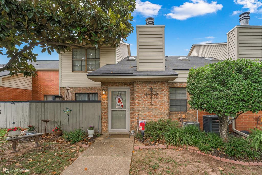 2 STORY LOFT CONDO IN NORTH BOSSIER! Welcome to Carriage Quarters, a quaint and well-maintained community of beautiful condominiums conveniently located in the heart of North Bossier! This unit is on the outer edge of the complex allowing more privacy than most! Driving up you'll notice 2 assigned covered parking spots for this unit as well as some additional parking if needed. There's a beautiful Magnolia tree in front of this unit with lovely landscaping creating a warm welcome. Step inside to find 1297 square feet, 2 bedrooms, 2 bathrooms, a loft space, and an open concept layout. The living room has a cozy wood burning fireplace and gorgeous wood-look ceramic tile floors. The dining space has plenty of room for your table and chairs to entertain guests. The kitchen has ample cabinetry and a breakfast bar for bar stools. The primary bedroom is downstairs with a private patio, a walk-in closet, and a makeup vanity area with a sink. Full bathroom has a newly installed tub shower combo. Utility area large enough for a full-size separate washer and dryer. Upstairs you'll find a loft space that could serve as a home office or flex space. Large second bedroom upstairs with a private bath. HOA fees of $325 per month cover water, sewer, trash, community pool, entry gate, tennis court, outside pest control, grounds maintenance, roof, and flood insurance. Roof installed in 2025 and water heater replaced in 2025. Nestled between Airline and Benton with easy access to WK Bossier, I-220, and all shopping and dining options that North Bossier has to offer. If you're looking for affordable and low maintenance living, I encourage you to come check out this property!