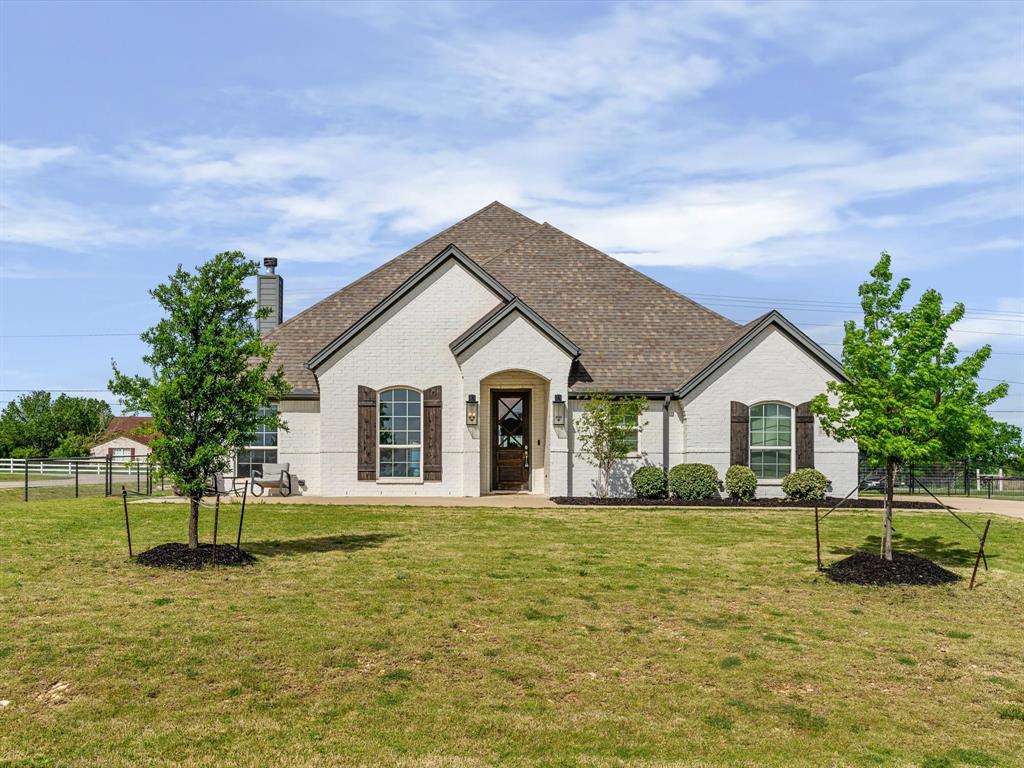 NEW CARPET IN ALL BEDROOMS & NEW BASEBOARDS INSTALLED. MOTIVATED SELLERS!  Welcome to this stunning custom-built Brookson home, perfectly situated on a spacious half-acre corner lot in a quiet cul-de-sac within the highly sought-after Legacy Ranch community in Justin, Texas. From the moment you arrive, the painted brick exterior, charming cedar shutters, and elegant uplighting create unforgettable curb appeal both day and night.

Step inside to a warm and inviting entryway featuring beautiful wood-look tile that flows seamlessly throughout the main living areas, including the kitchen, dining room, living room, and private master retreat. The thoughtfully designed kitchen is a true showstopper, boasting quartz countertops, a classic white farmhouse sink, upgraded faucet, and a convenient pop-up outlet at the oversized island—perfect for both everyday living and entertaining.

This home offers 4 spacious bedrooms and 2 full bathrooms, with upgraded tile work adding a touch of luxury to both baths. Every detail has been carefully selected to blend style, comfort, and functionality.

If you’re looking for modern finishes, a functional layout, and room to breathe—all in a prime location—this one checks every box.