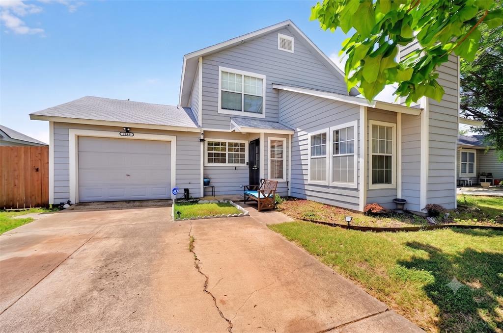 WELCOME HOME to this charming 3-bedroom, 2-bathroom gem in Arlington, where 1,579 square feet of thoughtfully designed living space wraps you in warmth the moment you walk through the door. The living room commands attention with dramatic symmetrical vaulted ceilings that soar overhead, a cozy wood-burning fireplace perfect for cool Texas evenings, and LVP flooring that flows seamlessly underfoot. Natural light pours through skylights along the staircase, giving the home an airy, open energy that feels anything but ordinary. The kitchen is made for real life with white shaker cabinets, quartz countertops, subway tile backsplash, stainless steel appliances including a Whirlpool range, and a pass-through window that keeps the cook connected to the dining room action. Upstairs, the primary suite is your private retreat, complete with a skylit en-suite bathroom and quartz vanity. Two additional bedrooms offer flexibility for guests or a dedicated home office. The upper loft bonus room overlooking the living area is the kind of space everyone will claim as their own. Washer and dryer convey! Step outside to a wood deck off French doors, a fully fenced backyard with mature shade trees, and room to make it yours. This home sits in an established neighborhood minutes from Six Flags, AT&T Stadium, Globe Life Field, I-20, and Cowboys Way, and about a 30 minute drive to Downtown Dallas. Claim Your Piece of Texas!