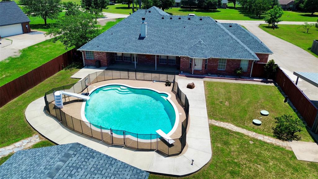 Turn-key Summer Oasis! Bring all offers! Price improvement AND seller to pay $4,000 toward buyer expenses. Come see this gorgeous 4-bedroom, 3.5 bath country home with all the bells and whistles—within commuting distance to Dallas. Lots of amenities and value, with some $35K in improvements over the past four years, including bathroom upgrades and a new wooden fence, per owner. Relax by the in-ground gunite pool, with a newer pump and motor, or enjoy the cabana's wood-burning fireplace on fall evenings. Home sits on a landscaped acre lot with a backyard batting cage for the kids and a chicken coop. Living room features wood floors, vaulted ceilings and corner fireplace; kitchen offers granite counter tops, breakfast bar, island, double appliances; walk-in pantry; full size sep. utility room w-sink; primary suite boasts vaulted ceilings, french doors leading to backyard, recently remodeled primary bathroom has sep. shower &  tub, sep. vanities & huge walk-in closet; a secondary jack-and-jill bathroom was remodeled within the past year as well; flex room off kitchen makes the perfect home gym, game room or office; upstairs bonus room can easily be used as a 5th bedroom or media room; outdoor shop w-covered parking; Pitching machine, pool basketball goal, and cabana furniture to remain with an acceptable offer.
