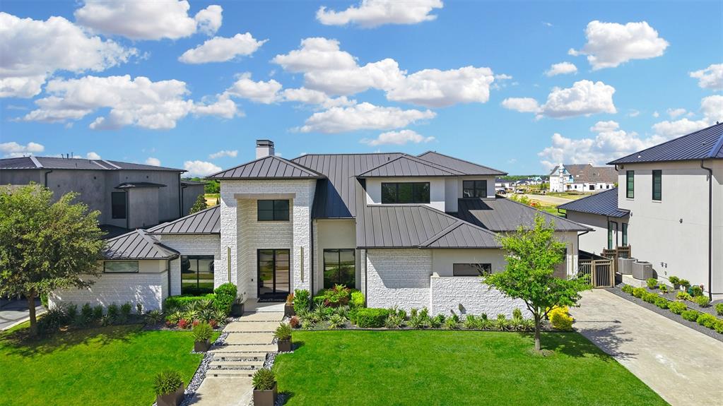 Nestled in the prestigious, guard-gated Hills of Kingswood, this Crest Custom home offers both luxury and ease. With five bedrooms and five baths, including a first-floor secondary suite, it’s designed for seamless living. The main level boasts a chef’s kitchen, butler’s pantry, and an inviting media-game room that overlooks the outdoor pool, spa, and kitchen. Upstairs, three ensuite bedrooms accompany a spacious media room. Hardwood floors throughout and a glass-door home office elevate the design, while a three-car garage and greenbelt views complete this exquisite retreat.