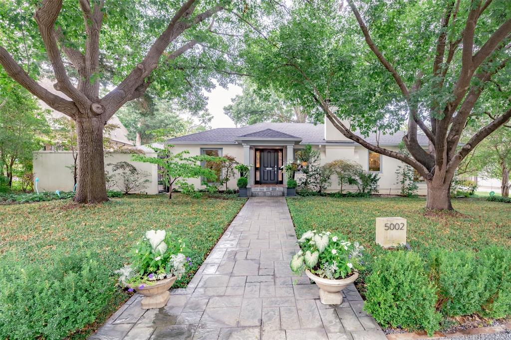 Nestled on a large corner lot in Bluffview, this move-in ready gem is fully updated with thoughtful upgrades. Mature trees and lush landscaping on the almost one-third acre create a shaded canopy and tranquil oasis through Asian jasmine in front and a separate Zen garden with koi pond. A private wing houses the spacious master suite. Hardwood floors throughout connect the spaces. The great room opens to a screened-in loggia with views of the turf backyard and pool. The pool filter and salt system were replaced in 2017. Additional features include a gym area, infra-red sauna, generator, moonlight tree lighting, upgraded fireplace and kitchen light fixtures. Recent enhancements to the property are attic insulation removal and replacement (2020), roof replaced (2021), window installation (2021), and two water heaters (2023).