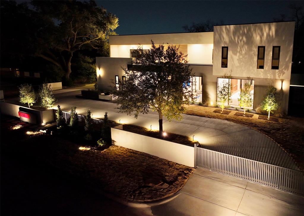 NEW CONSTRUCTION – MOVE-IN READY. Experience next-level luxury and innovation in this steel-frame contemporary masterpiece, ideally situated in the prestigious private school corridor. Thoughtfully designed for modern living, this exceptional residence offers 5 spacious bedrooms, including a versatile first-floor secondary suite—ideal for guests or multi-generational living. Boasting 6.5 designer bathrooms and a private study overlooking the manicured front grounds, every detail reflects refined craftsmanship and intentional design. The expansive layout features two sophisticated living areas on the main level and three additional living spaces upstairs, providing exceptional flexibility for both everyday living and grand entertaining.
The open-concept chef’s kitchen is a true showpiece, appointed with premium Wolf appliances, a Sub-Zero refrigerator, bespoke cabinetry, and elegant surfaces. A separate prep kitchen and built-in coffee station further enhance both function and style. The luxurious primary suite is a true retreat, featuring a spa-inspired bath and expansive his-and-hers walk-in closets, thoughtfully designed for both comfort and functionality. Seamless indoor-outdoor living continues with a low-maintenance turf backyard complete with a stylish lounge area and built-in grill—perfect for year-round entertaining. The gated front yard offers added privacy and security, complementing the circular driveway and striking curb appeal. Additional highlights include a 3-car garage, a finished balcony with multiple seating areas, soaring ceilings, and exquisite custom millwork throughout. Listing agent is related to the seller.