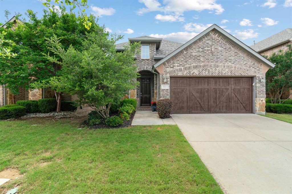 If you've been searching Lantana, you already know what you're looking for: not just a house, but a place to land. 921 Montgomery Way delivers exactly that — a 2,706 sq ft American Legend home, freshly carpeted and move-in ready, in southern Denton County's most established master-planned golf course community. The kind of neighborhood where the pool opens Memorial Day weekend, your kids meet their summer best friends within a week, and you actually know your neighbors' names by Labor Day. The floor plan is the one buyers keep asking for and rarely finding: primary suite PLUS a second bedroom and full bath on the main level — perfect for multi-generational families, visiting in-laws, out-of-town guests, or a private home office that doesn't share a wall with the kids. Upstairs delivers a dedicated game room AND a separate media room, plus two more bedrooms and a full bath. Movie nights, sleepovers, and quiet study time each get their own zone. The open-concept main floor flows from a soaring family room with cozy fireplace into a casual dining area and oversized eat-in kitchen built for both Tuesday-night homework and Sunday-afternoon gatherings. Energy-efficient construction — Low-E windows, 13–15 SEER HVAC, high-efficiency water heater, and programmable thermostat — keeps utility bills predictable. The brick-and-stone exterior and low-maintenance lot keep weekends free for actually living, not landscaping. The Lantana lifestyle is included: front yard maintenance, community pools, tennis, basketball, parks, playgrounds, a private pond, miles of jogging and bike paths, and year-round resident events from neighborhood movie nights to summer concerts. Community-wide gigabit fiber internet means you can take your first Zoom call before the boxes are unpacked. Location: Easy access to FM 407 and I-35W. Approximately 25 minutes to DFW International Airport, 30 minutes to AllianceTexas, and 35 minutes to downtown Fort Worth. Welcome home.