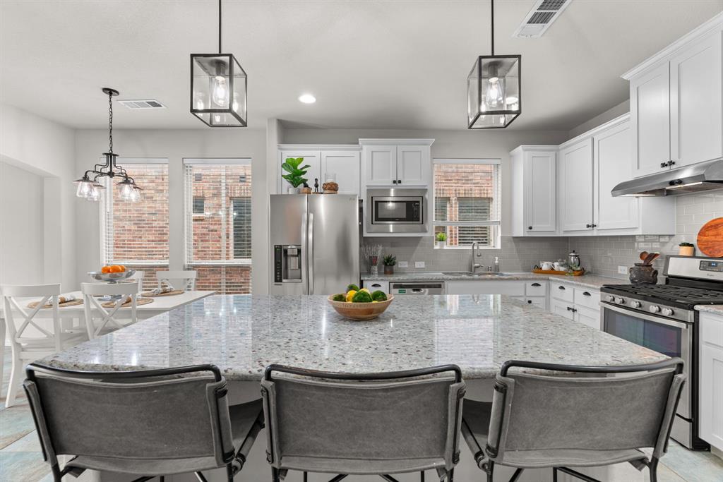 If you've been searching Lantana, you already know what you're looking for: not just a house, but a place to land. 921 Montgomery Way delivers exactly that — a 2,706 sq ft American Legend home, freshly carpeted and move-in ready, in southern Denton County's most established master-planned golf course community. The kind of neighborhood where the pool opens Memorial Day weekend, your kids meet their summer best friends within a week, and you actually know your neighbors' names by Labor Day. The floor plan is the one buyers keep asking for and rarely finding: primary suite PLUS a second bedroom and full bath on the main level — perfect for multi-generational families, visiting in-laws, out-of-town guests, or a private home office that doesn't share a wall with the kids. Upstairs delivers a dedicated game room AND a separate media room, plus two more bedrooms and a full bath. Movie nights, sleepovers, and quiet study time each get their own zone. The open-concept main floor flows from a soaring family room with cozy fireplace into a casual dining area and oversized eat-in kitchen built for both Tuesday-night homework and Sunday-afternoon gatherings. Energy-efficient construction — Low-E windows, 13–15 SEER HVAC, high-efficiency water heater, and programmable thermostat — keeps utility bills predictable. The brick-and-stone exterior and low-maintenance lot keep weekends free for actually living, not landscaping. The Lantana lifestyle is included: front yard maintenance, community pools, tennis, basketball, parks, playgrounds, a private pond, miles of jogging and bike paths, and year-round resident events from neighborhood movie nights to summer concerts. Community-wide gigabit fiber internet means you can take your first Zoom call before the boxes are unpacked. Location: Easy access to FM 407 and I-35W. Approximately 25 minutes to DFW International Airport, 30 minutes to AllianceTexas, and 35 minutes to downtown Fort Worth. Welcome home.