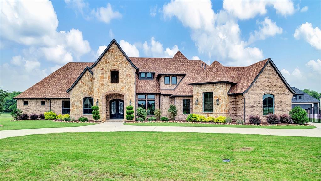 Gorgeous custom home on 2.75 sprawling acres in prestigious Lovejoy ISD! Enjoy the serene beauty of mature trees and ponds on this tranquil, tucked away cul-de-sac. Impressive circle drive leads to private entrance and 4+ car garage. Upon entry you are met with soaring ceilings, rich wood work, secret doors and designer lighting. Stunning great room flows seamlessly into chef's kitchen featuring luxury appliances, granite island, and custom cabinetry. Perfectly designed PREP KITCHEN with oversized pantry! Retreat to primary suite with luxurious spa bath, large custom closet, and more serene views. This thoughtfully designed floor plan offers 4 additional bedrooms all with ensuite baths and walk in closets. Enjoy a media experience, game room, or home gym in the 800+ ft basement with wet bar and full bath! The backyard offers unparalleled privacy featuring outdoor kitchen, fireplace, and sparkling fountain views! Perfect for entertaining or quiet evenings under the stars. Luxury meets comfort around every corner in this one of a kind property! It truly is a must see!