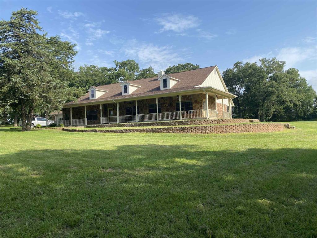 Private Country Retreat with Space, Shop, and Pond! Enjoy peace and privacy with this well-built home set back from the road and backing up to an 82-acre ranch. Conveniently located near Hwy 175, you’ll have the feel of country living while still being close to town and commuting routes. This spacious home offers 4 bedrooms, 3 full baths, and 2 half baths. The large living room opens to a generous kitchen featuring abundant cabinets, double ovens, two cooktops, a breakfast bar, and a breakfast area—perfect for everyday living and entertaining. A formal dining room with built-ins and a separate formal living room provide additional space. The primary suite includes two walk-in closets, dual vanities, a walk-in shower, and a garden tub. One bedroom features built-ins, a Murphy bed, and private porch access, while the other two bedrooms each have their own bathrooms. Outside you’ll find a drive-thru garage, workshop, pond, and massive enclosed sunroom. A perfect blend of privacy, space, and convenience.
