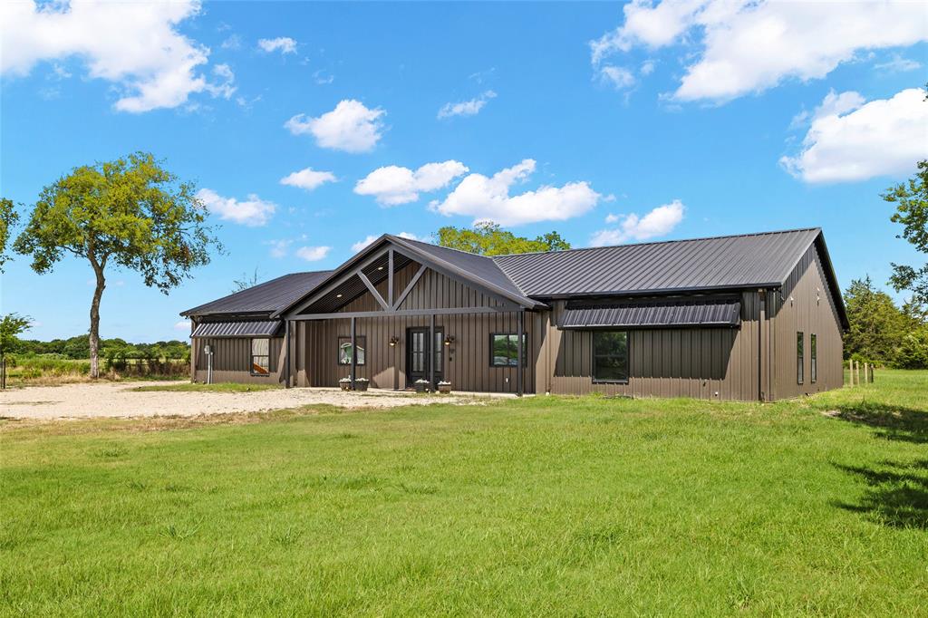 Experience the perfect blend of custom luxury and country charm in this stunning dream home. This beautifully designed 5-bedroom, 3.5-bath residence offers exceptional space, style, and thoughtful upgrades throughout. A versatile bonus room adds flexibility for a media space, game room, or home office.
At the heart of the home, the expansive 9x5 granite island anchors a chef-inspired kitchen, complete with a coffee bar and pot filler—perfect for entertaining or everyday living. The fully custom interior showcases handcrafted vanities, rich wood beams, vaulted ceilings, and striking farmhouse chandeliers, creating a warm yet elevated aesthetic.
The private primary suite is a true retreat, featuring a spa-like bathroom with a double walk-in shower, freestanding soaking tub, and dual custom vanities. A separate guest suite with its own full bath is thoughtfully positioned on the opposite side of the home for added privacy.
Designed for convenience and efficiency, the home includes two laundry rooms, foam insulation, security lighting, and ceiling fans in every bedroom. Step outside from the primary suite through sliding glass doors to a spacious covered patio, ideal for relaxing or entertaining under the Texas sky.
Situated with both well water and Poetry water, and featuring a poured shop slab ready for your future build, this property offers the perfect balance of functionality and lifestyle.
This one truly has it all—custom design, modern comfort, and room to make it your own.